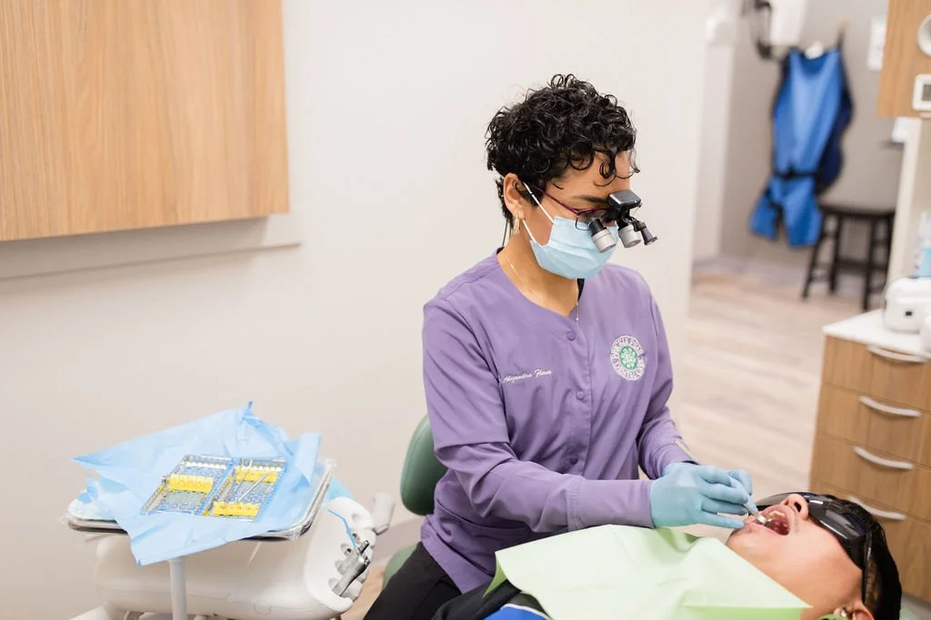 A patient receiving a dental cleaning from Dr. Flores in the office of Prickly Pear Dental Care.