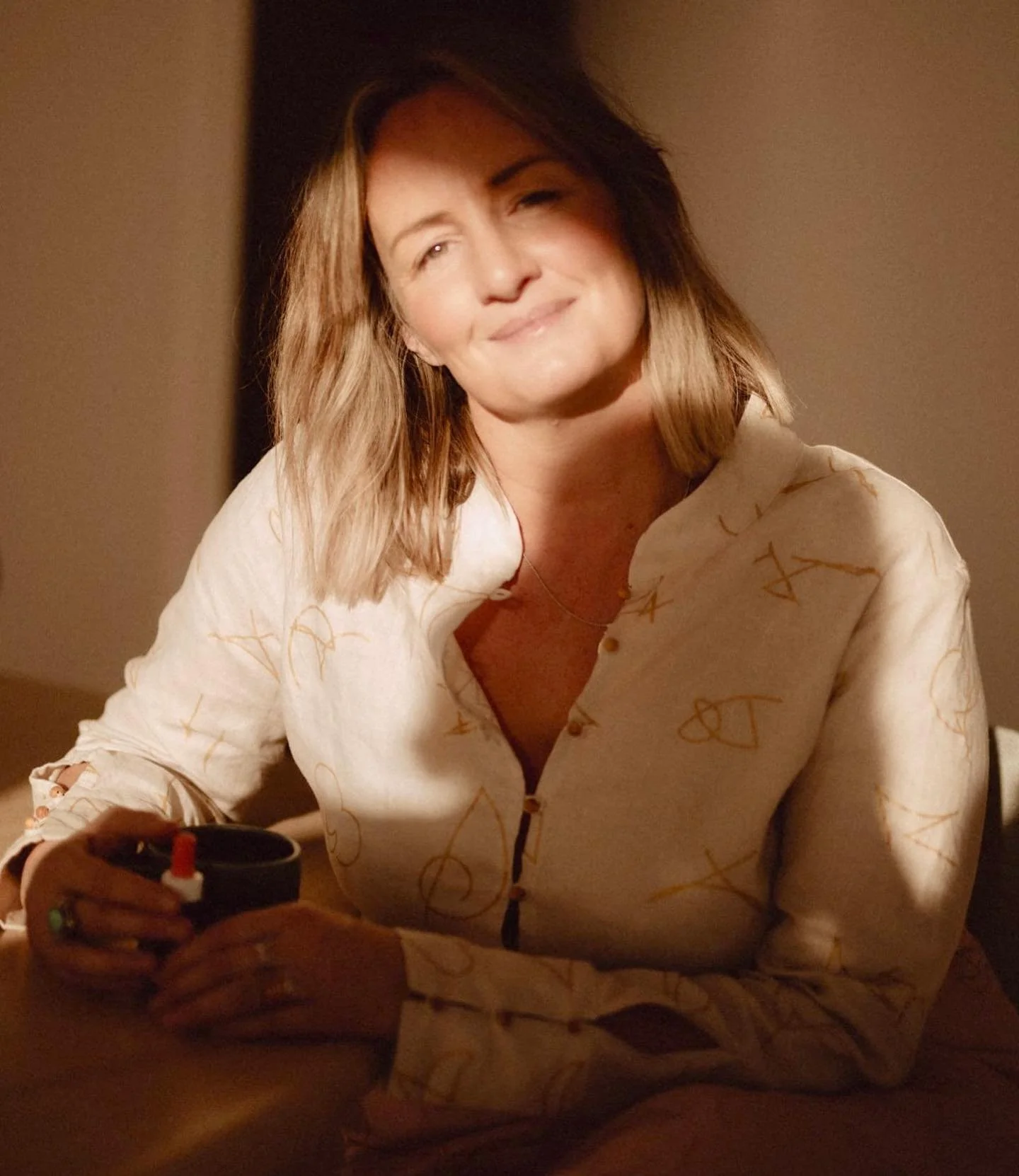Serenity shirt in Bone worn by @candicejhooper_ whom embodies an ode to quiet confidence and conscious elegance. 
Crafted in organic linen, the Light Language Bone Serenity Shirt features sacred sandalwood buttons &mdash; a subtle signature of sacred