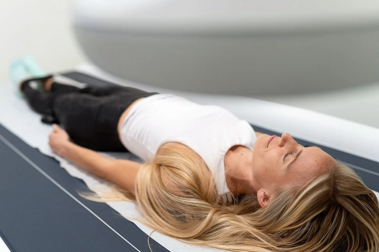 woman performing a DEXA scan
