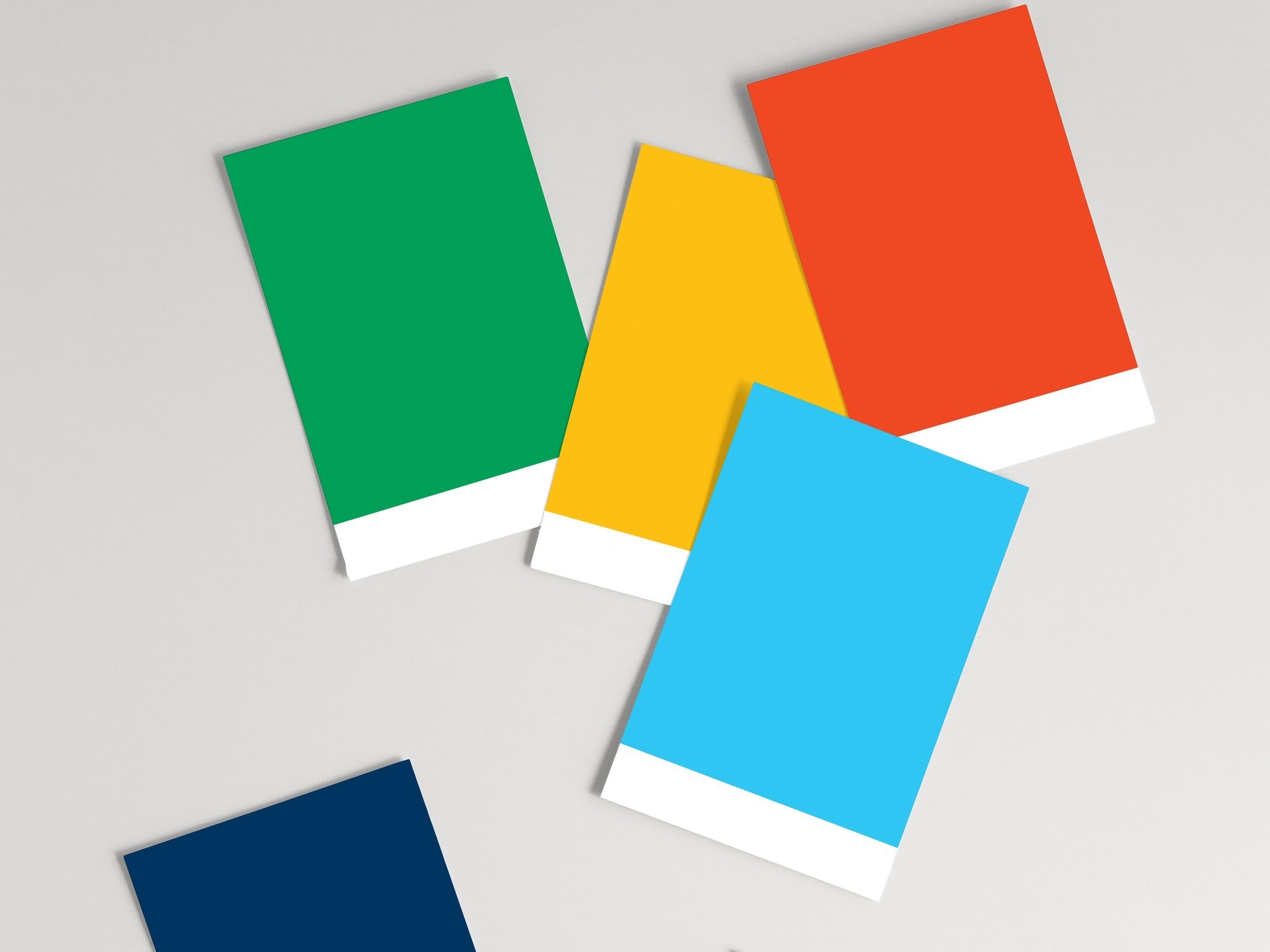 Colorful rectangular cards in green, yellow, red, blue, and navy blue spread on a white background.