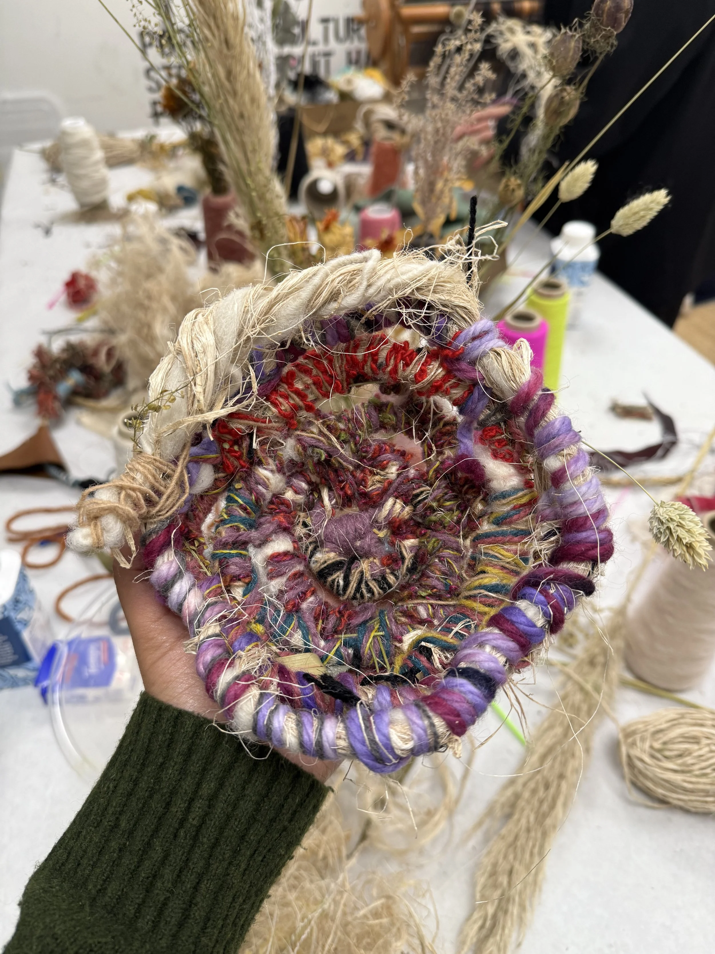 Textile sculpture created during a Peel Studio workshop using natural fibres, reclaimed yarns, and experimental weaving techniques.