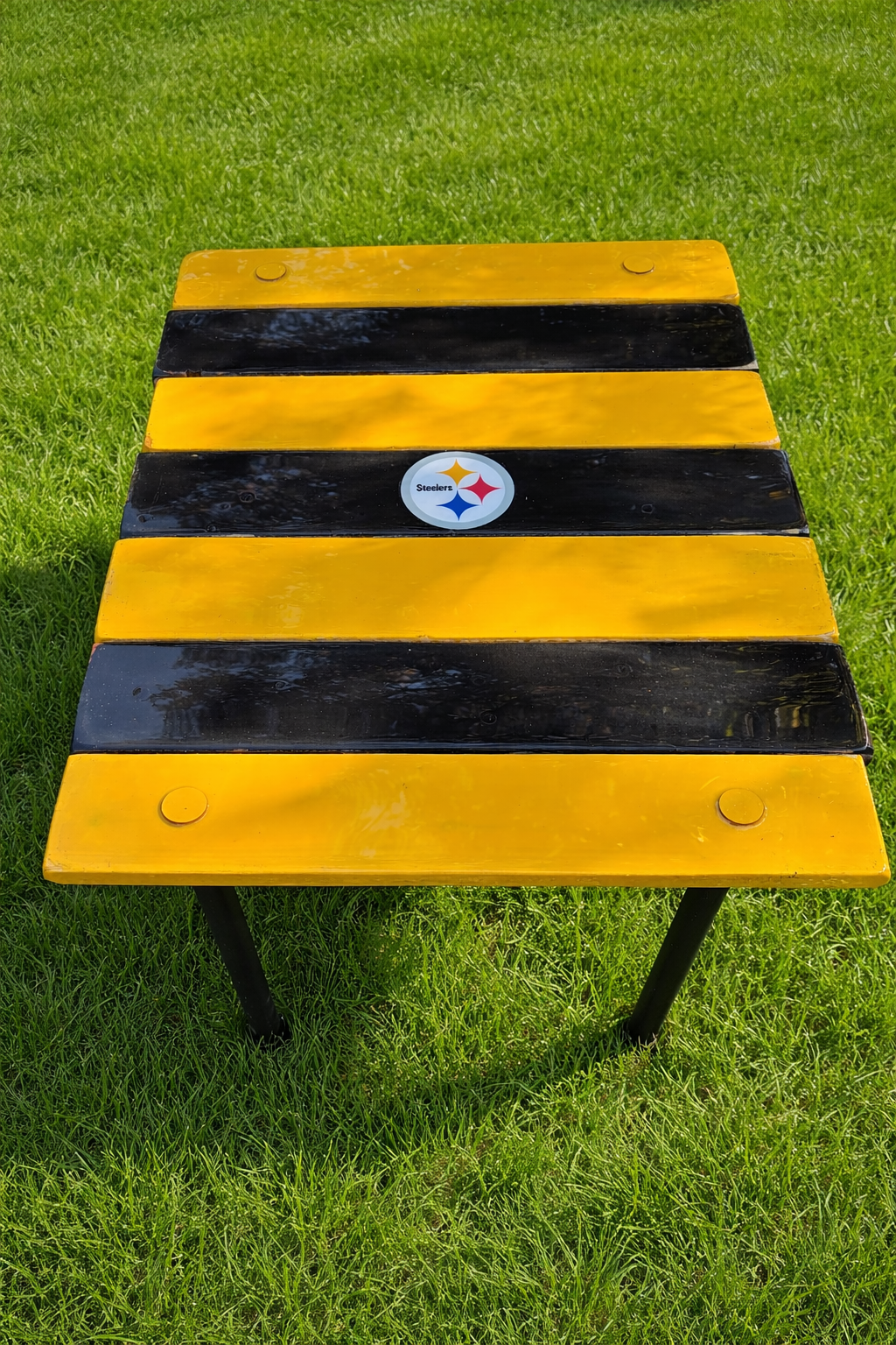 Pittsburgh Steelers roll-out table in a bag on bright green grass, black and gold cedar portable table by S & M Woodmasters
