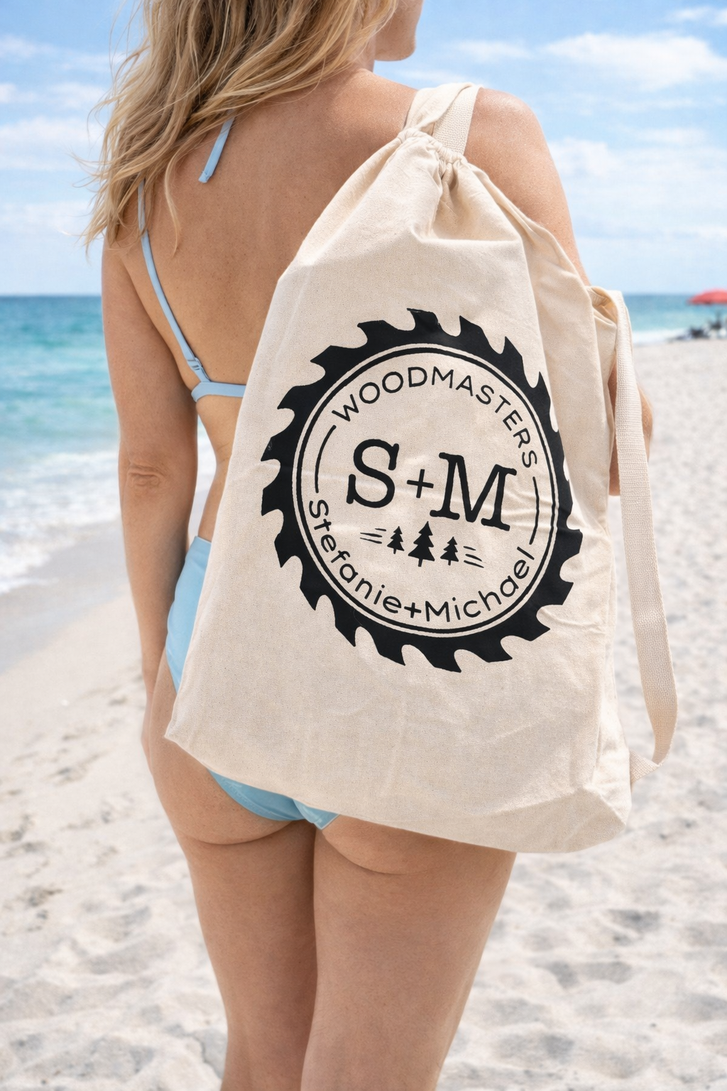 A girl in a blue bathing suit carrying a roll out table bag (Copy)