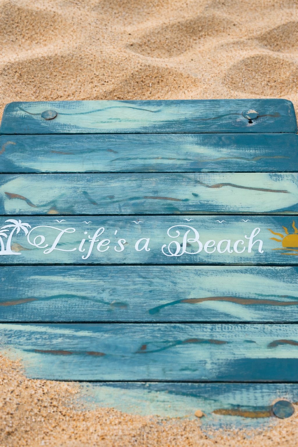 life's a beach turquoise portable beach table in a bag on the beach at sunrise