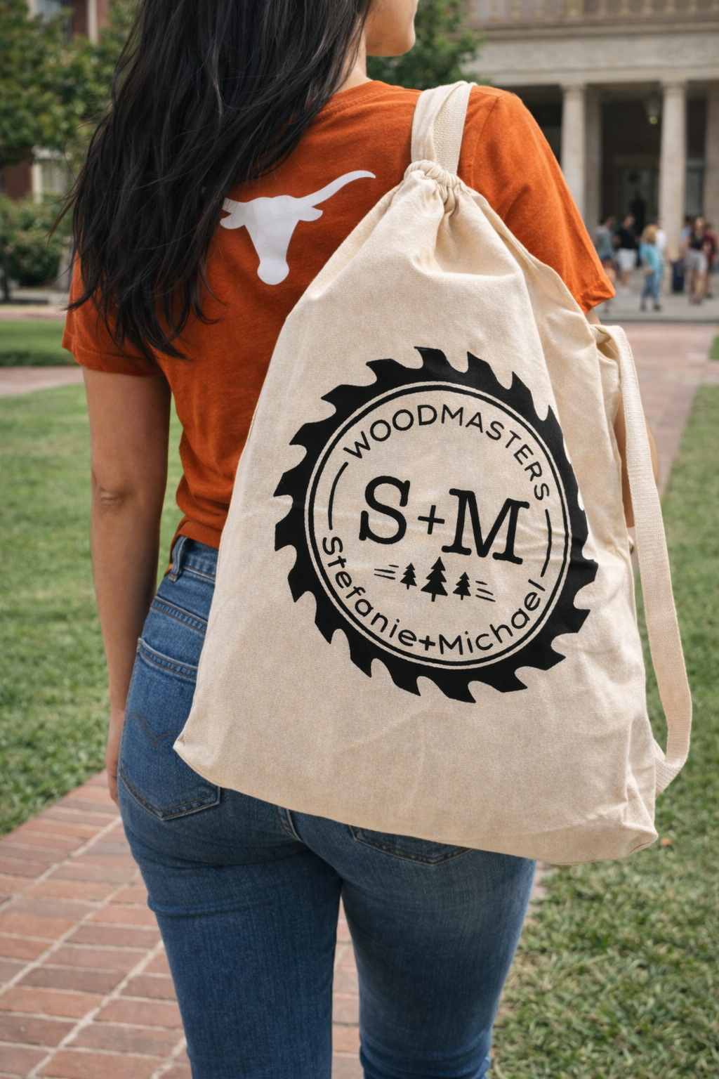 Student carrying a canvas roll-out table bag on a University of Texas campus, portable over-the-shoulder carrying bag included with table
