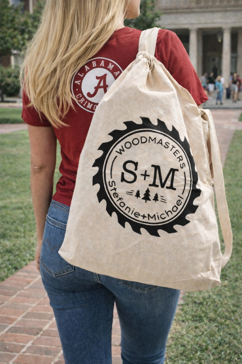 Alabama fan carrying S & M Woodmasters canvas bag on college campus