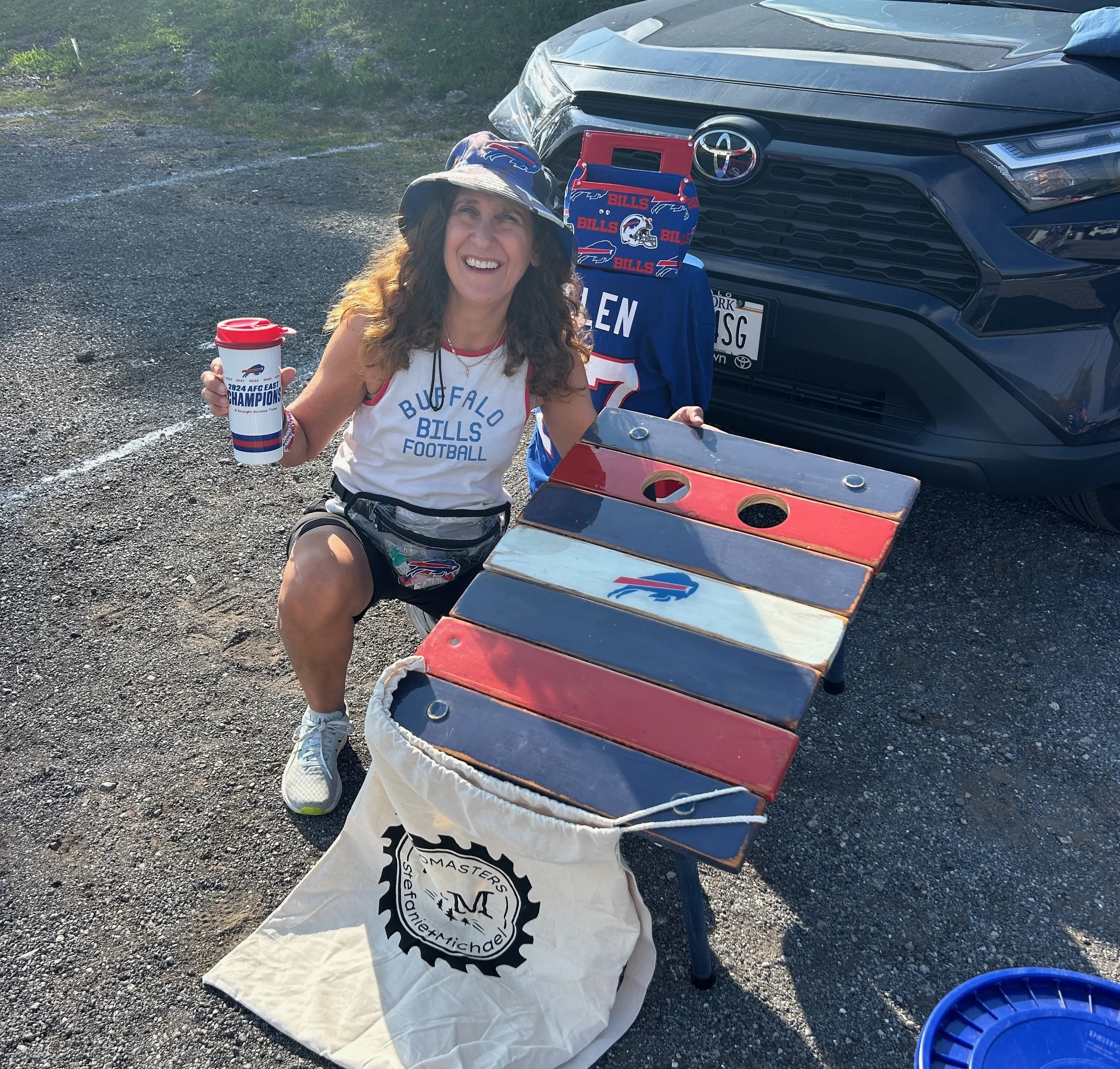 a buffalo bills roll out table in a bag with a female fan tailgating