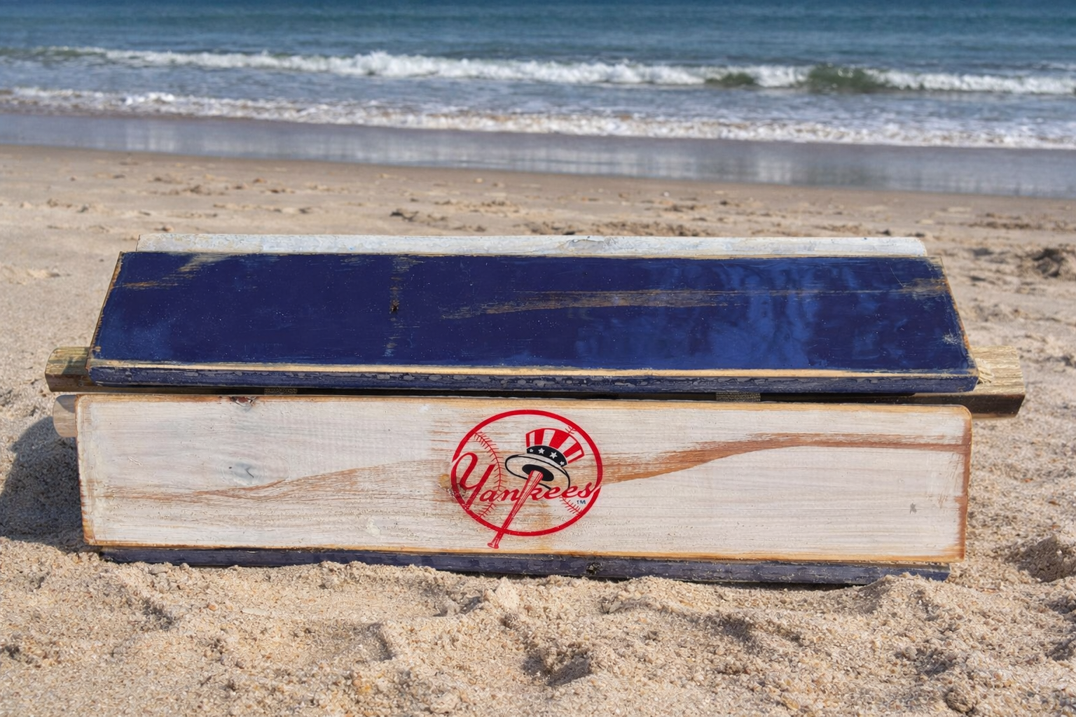 Handcrafted New York Yankees roll-out table in a bag with navy and white cedar boards, portable folding tailgate table rolled up on the beach