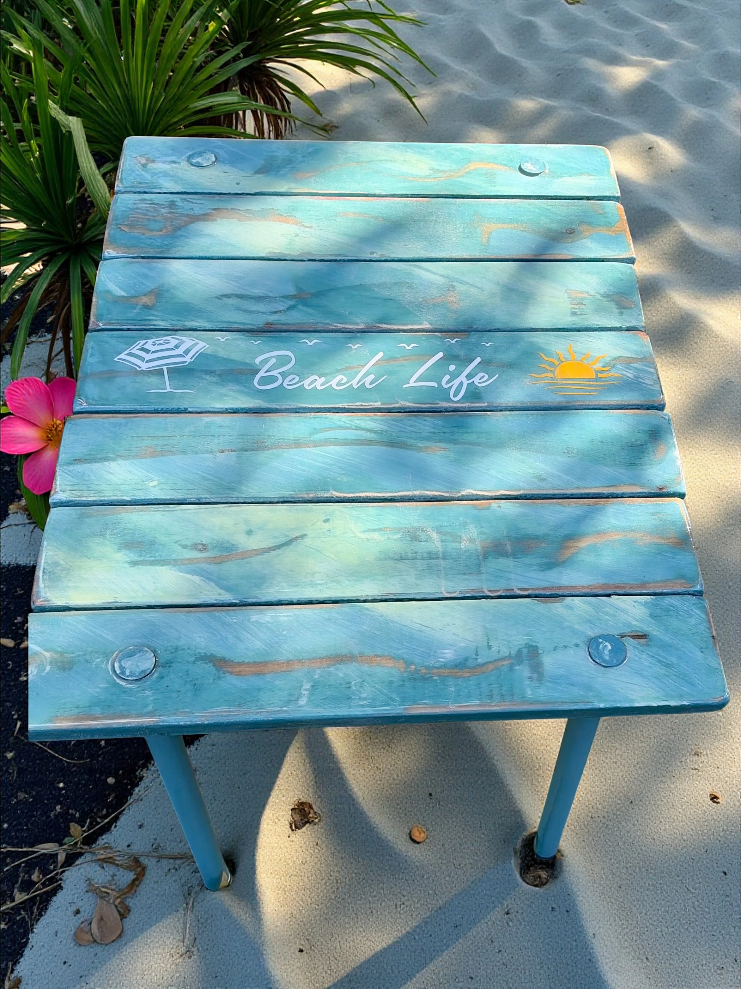 a turquoise beach table that says beach life by the pool