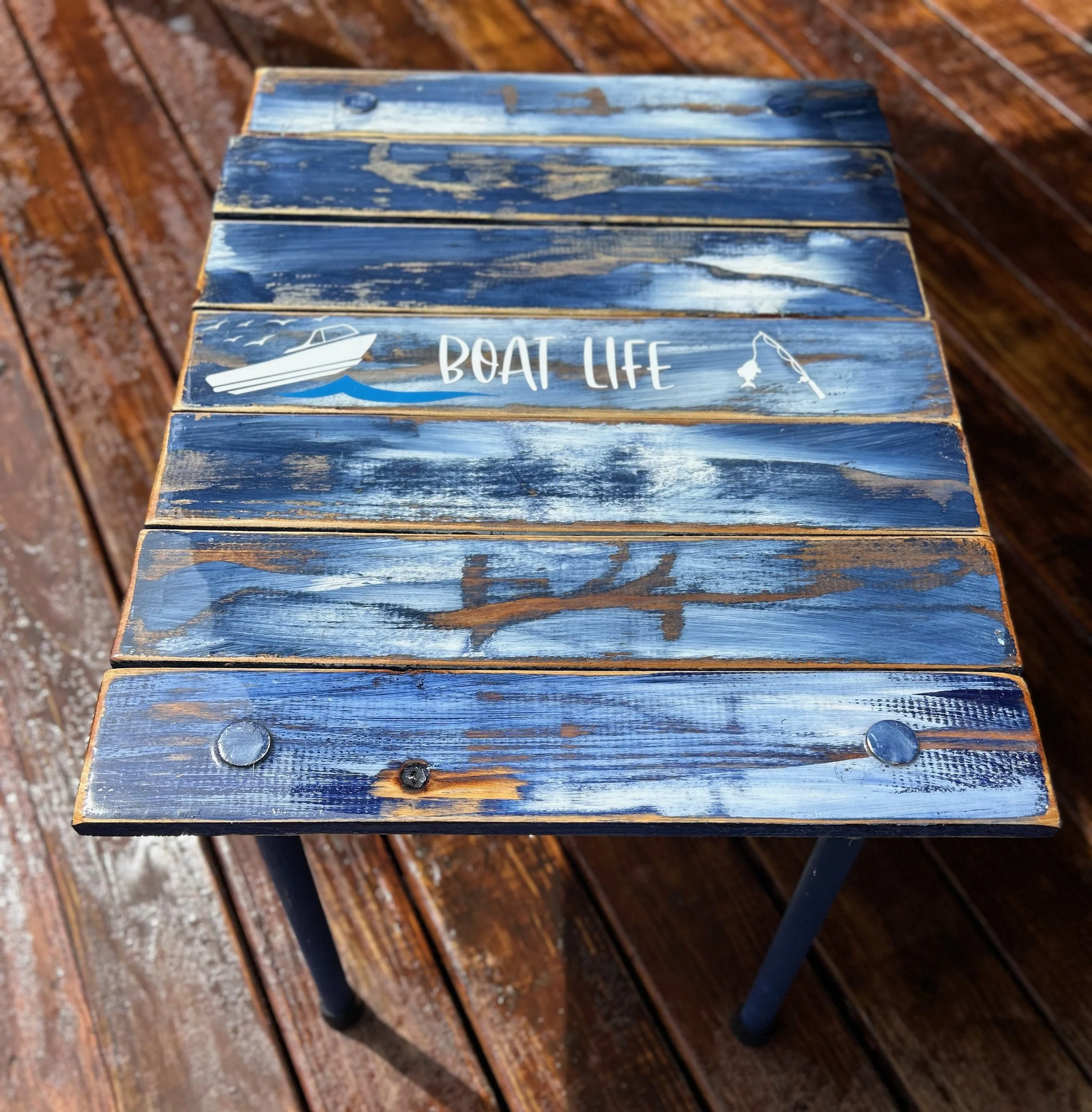 denim blue cedar boat life roll out table on a patio deck