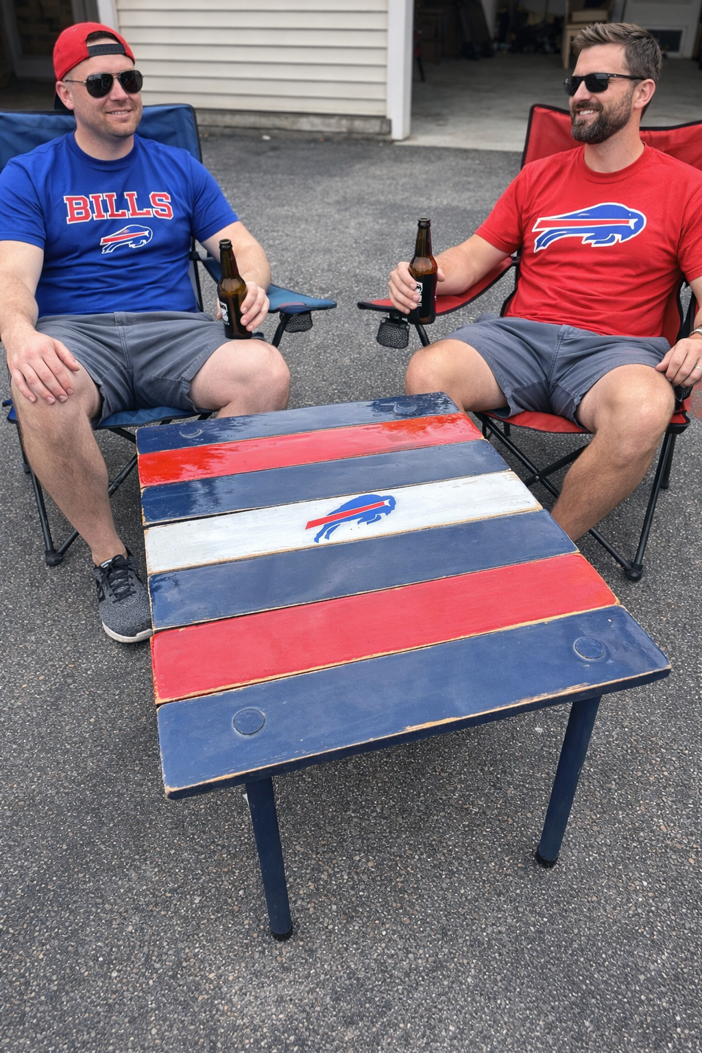 a buffalo bills roll out table in a bag with two male fan tailgating in their driveway