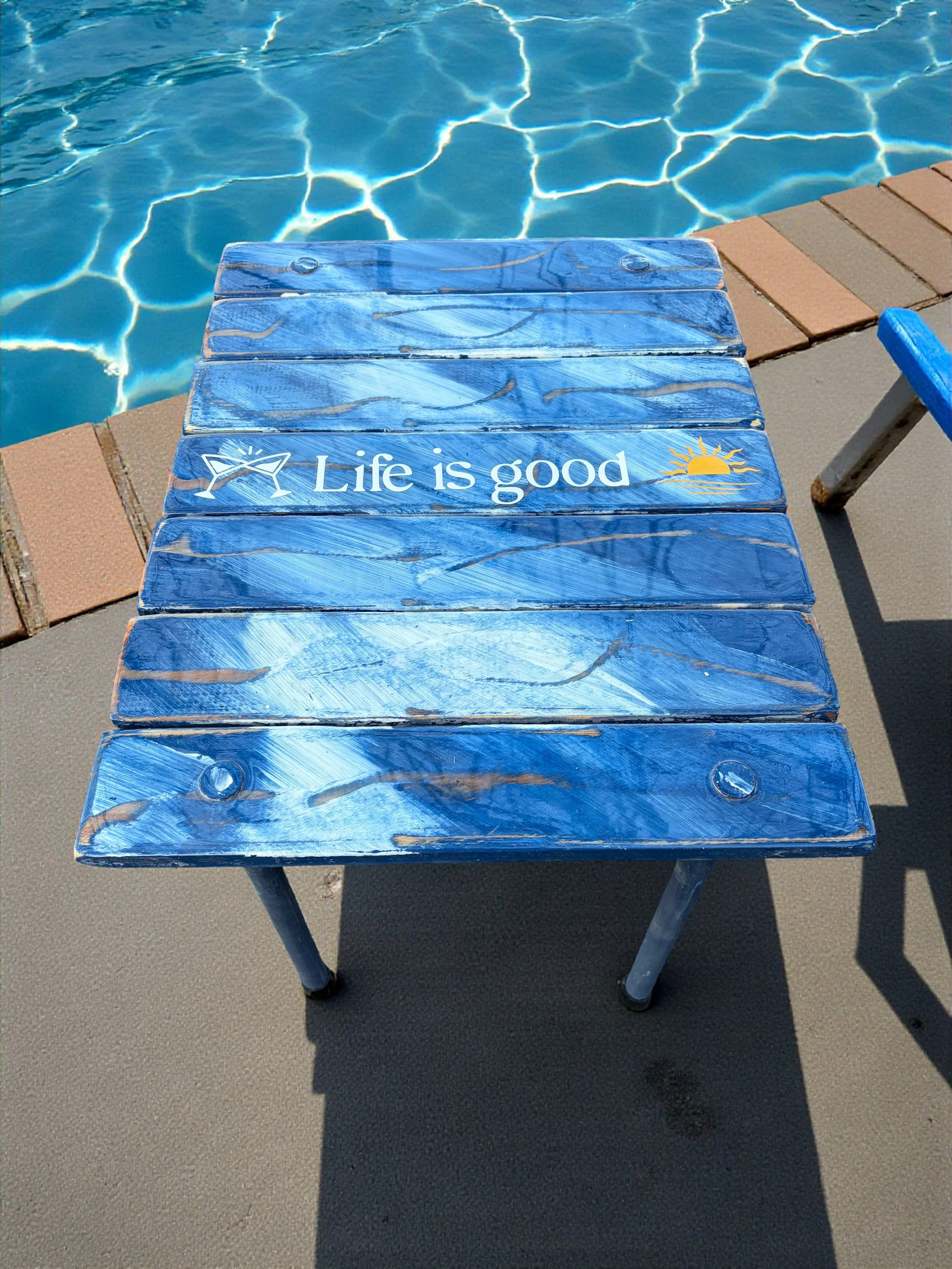 denim blue roll out table in a bag that says life is good by the poolside