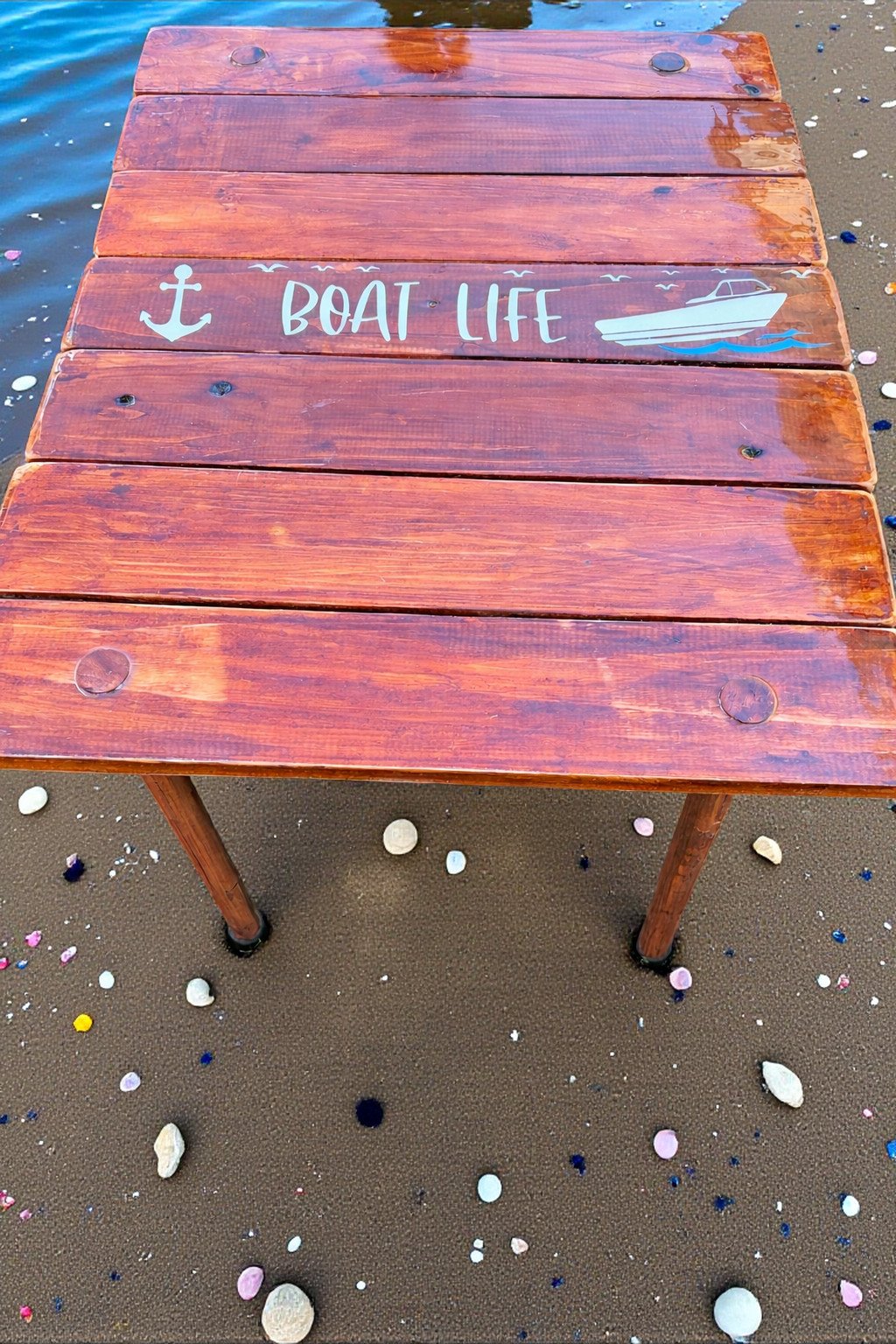 Handcrafted cedar roll-up table in a bag on a beach