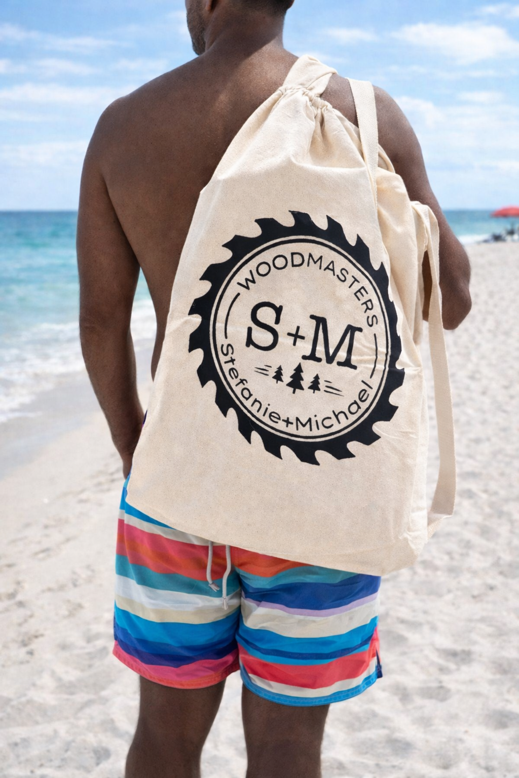 a black man holding smwoodmasters roll out table in a bag