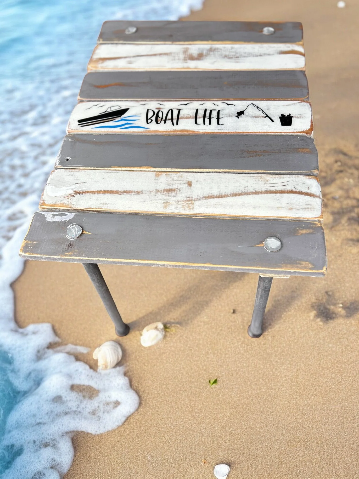 gray-white-boat-table-on-beach.jpg