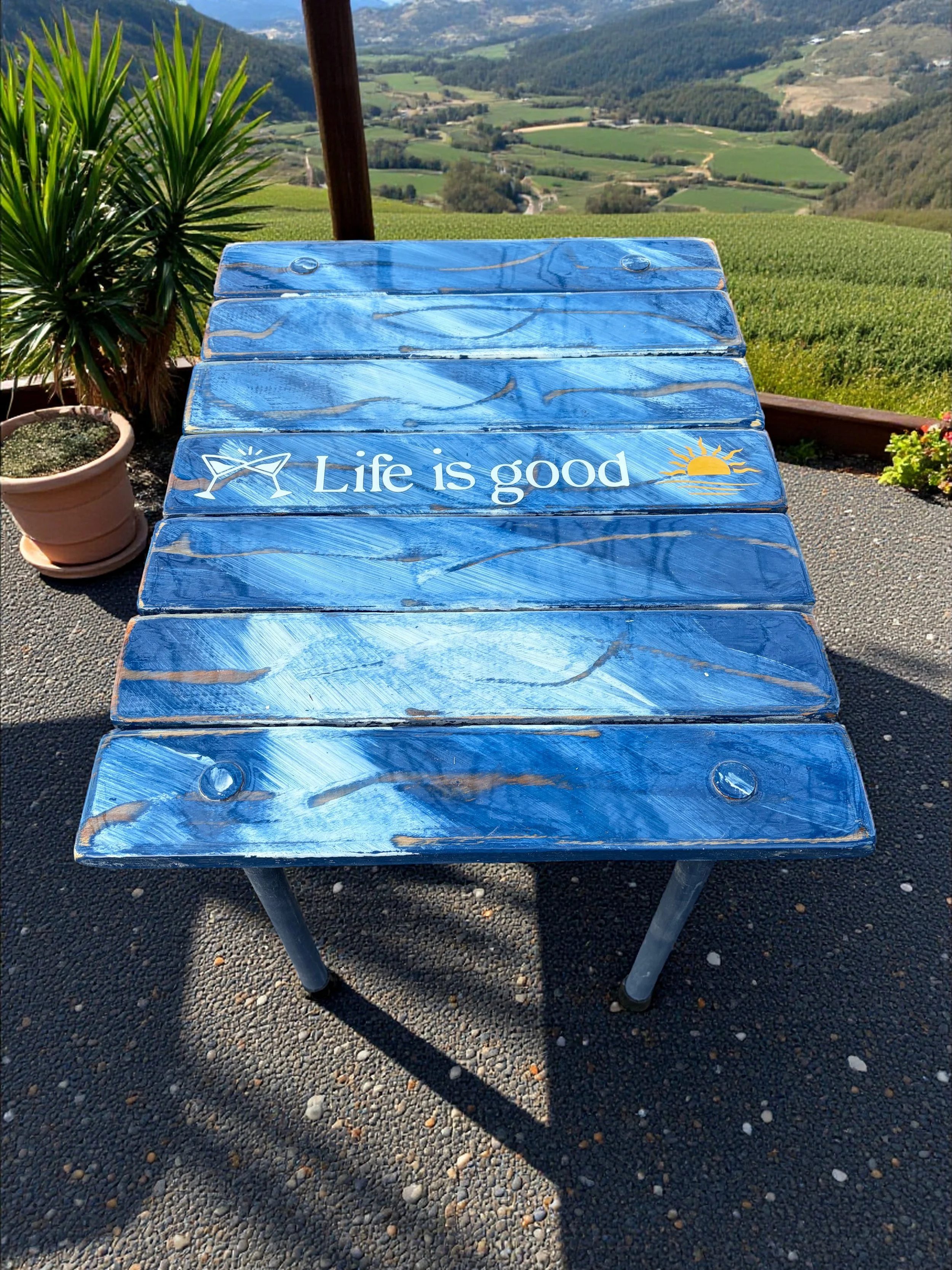 denim blue roll out table in a bag that says life is good on the beach