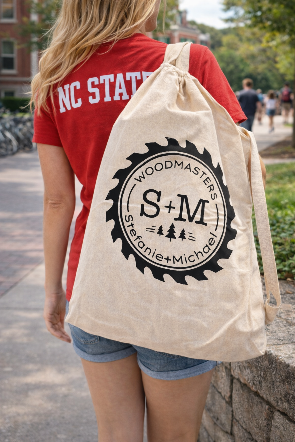 Signature canvas Roll-Out Table carry bag worn on a college campus by a student in an NC State shirt