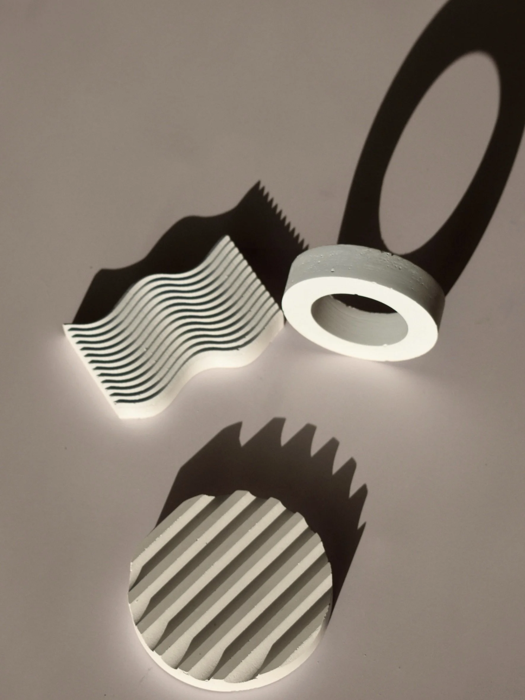 Drei Skulpturen und schwarzer und weißer Schatteneffekt.