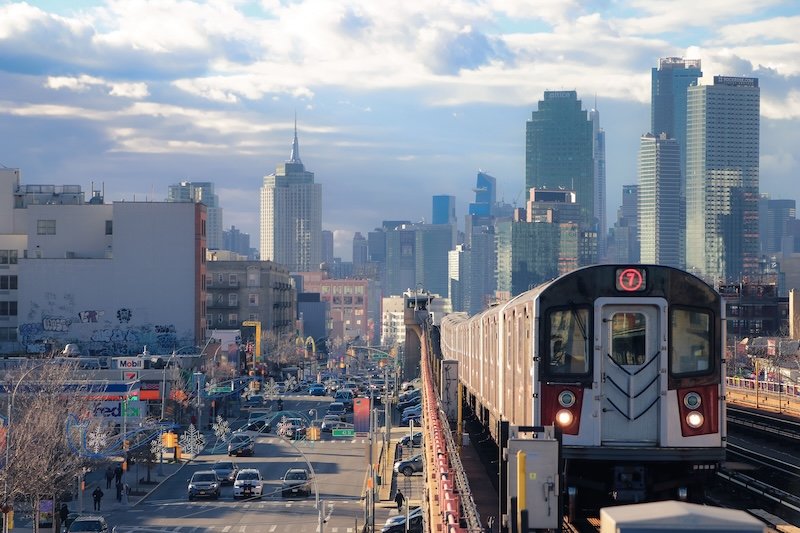 MTA 7 train in Queens with Manhattan skyline representing Hudson Yards Clean cleaning service areas across NYC boroughs