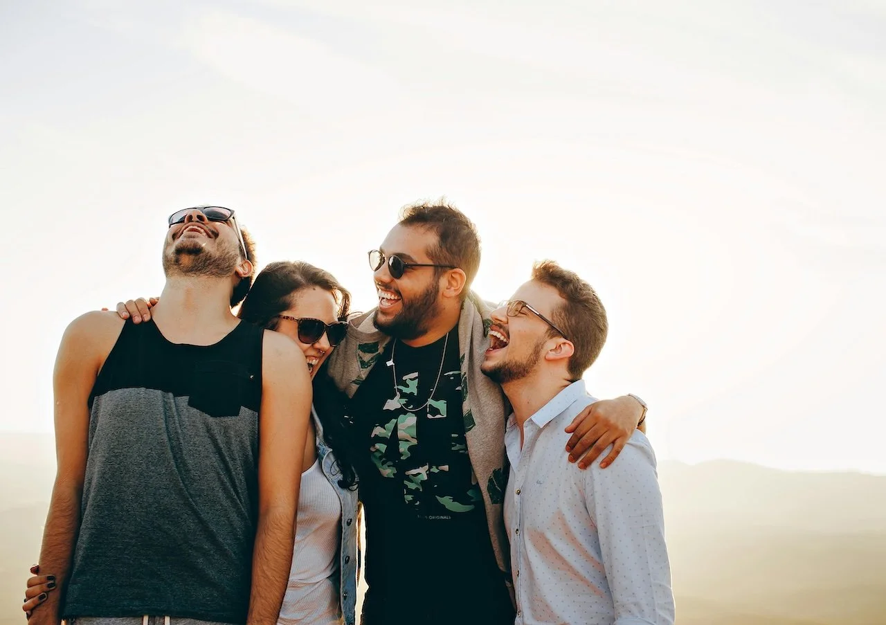Group of friends laughing and smiling together.