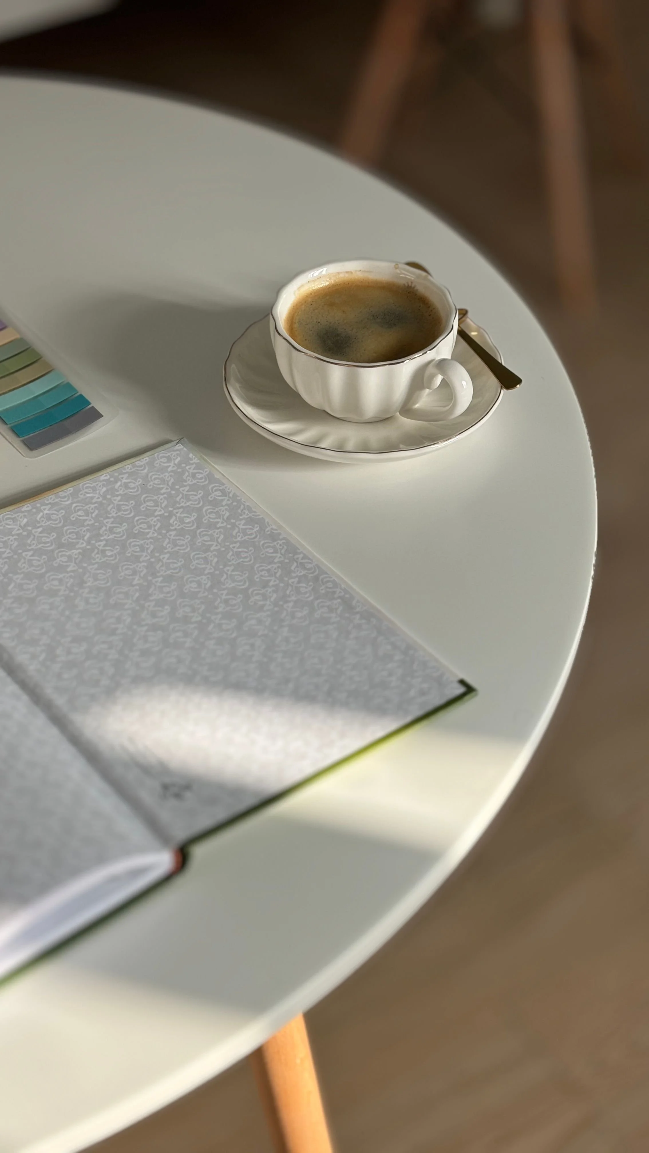 Therapist taking intentional planning time with coffee and notebook