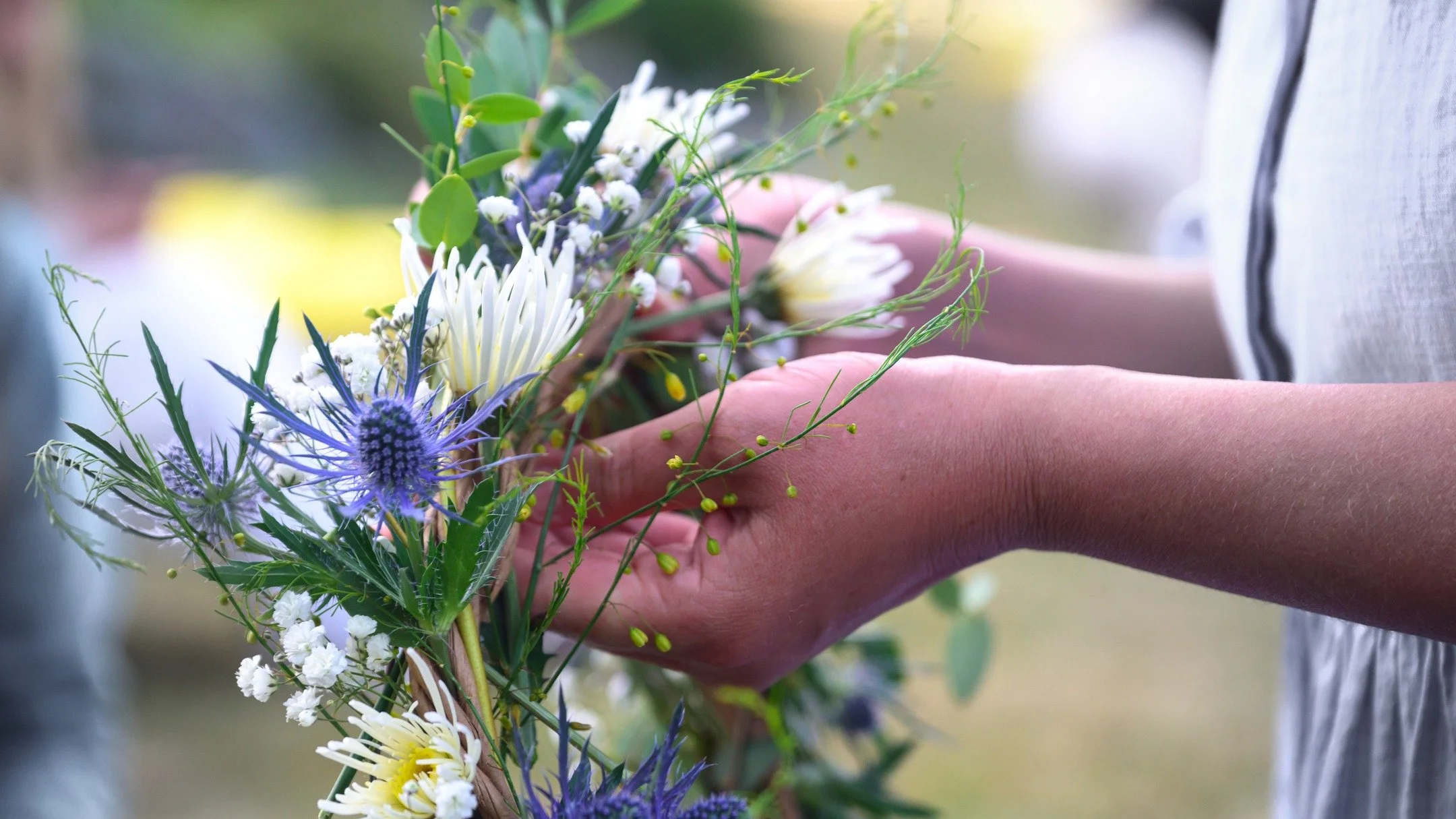 A beautiful floral crown featuring asparagus greens and sea holly.