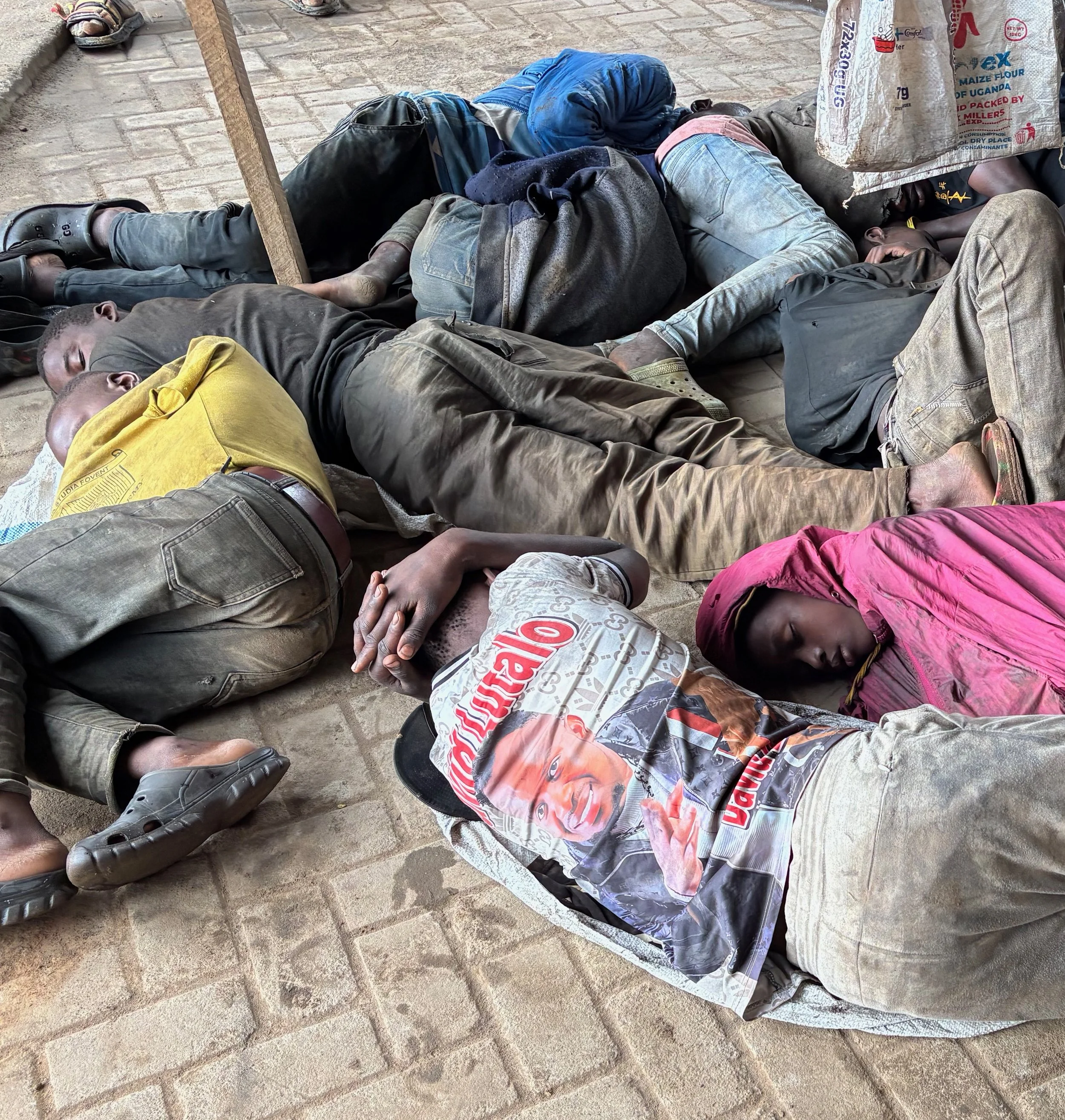 Before the food arrived, a dozen of them lay in a sodden mass on the ground, packed close together to conserve warmth.