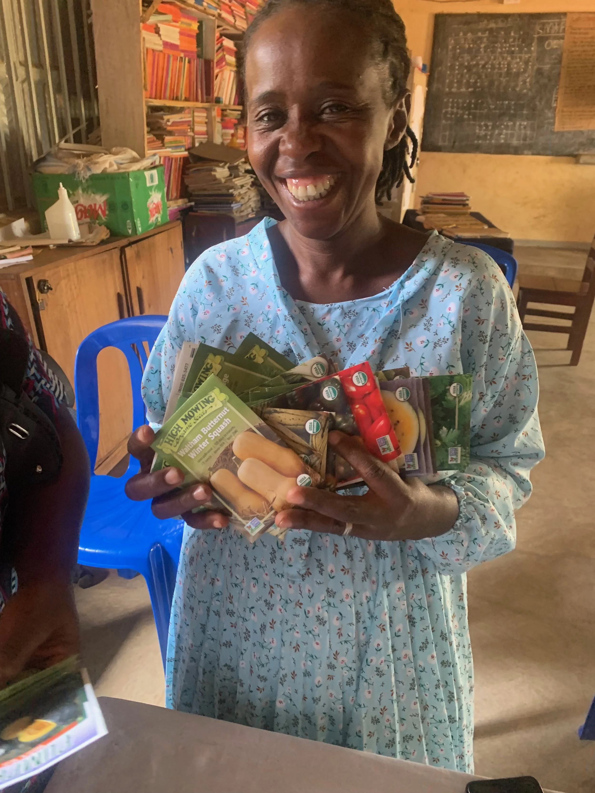 Teacher Emilly with some of the hundreds of vegetable packets we have donated to enhance the school gardens. The produce will increase the nutrition in the childrens’ meals, and planting, tending, and harvesting the food will provide learning skills 