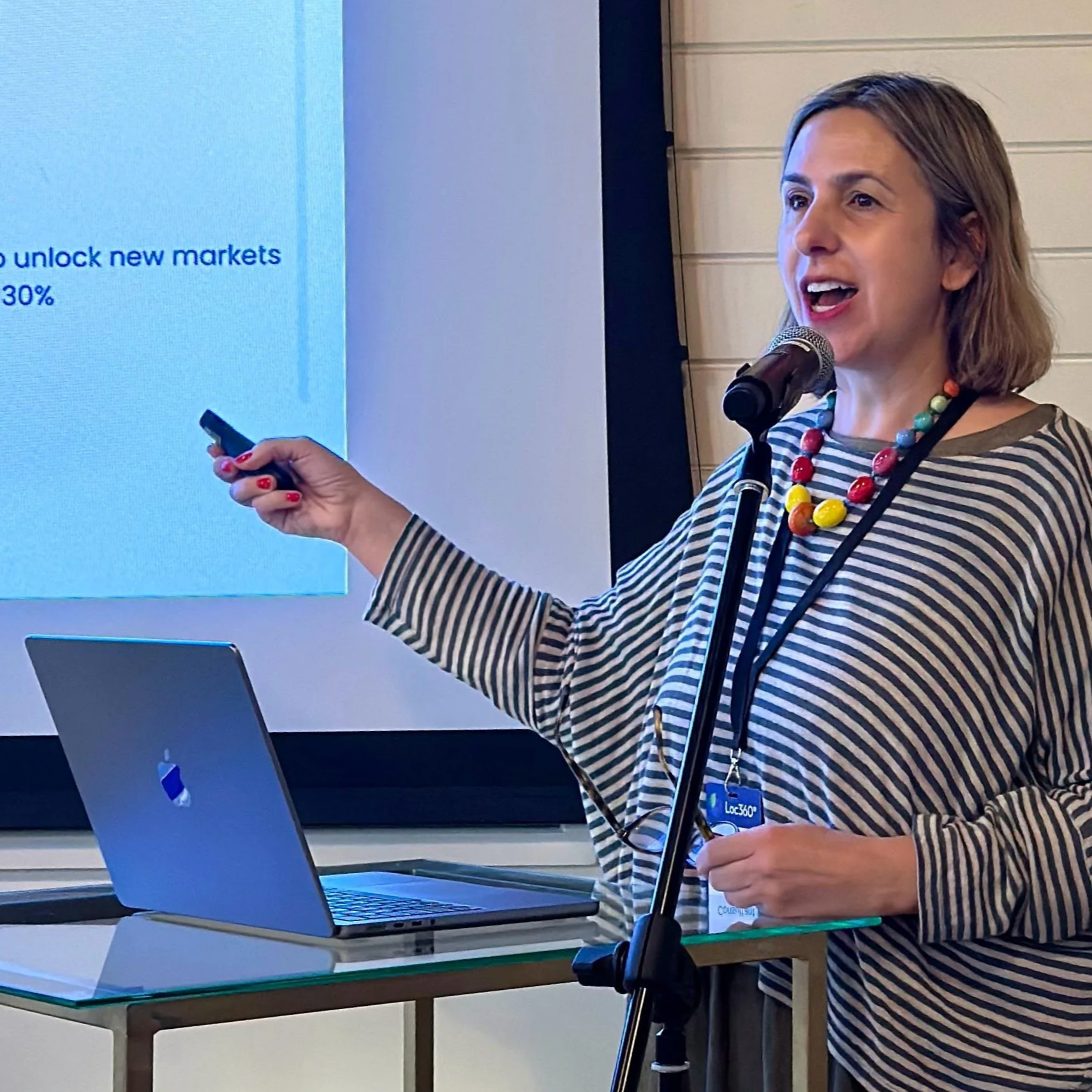 Giulia Greco, a woman and professional, speaking at a podium during an event
