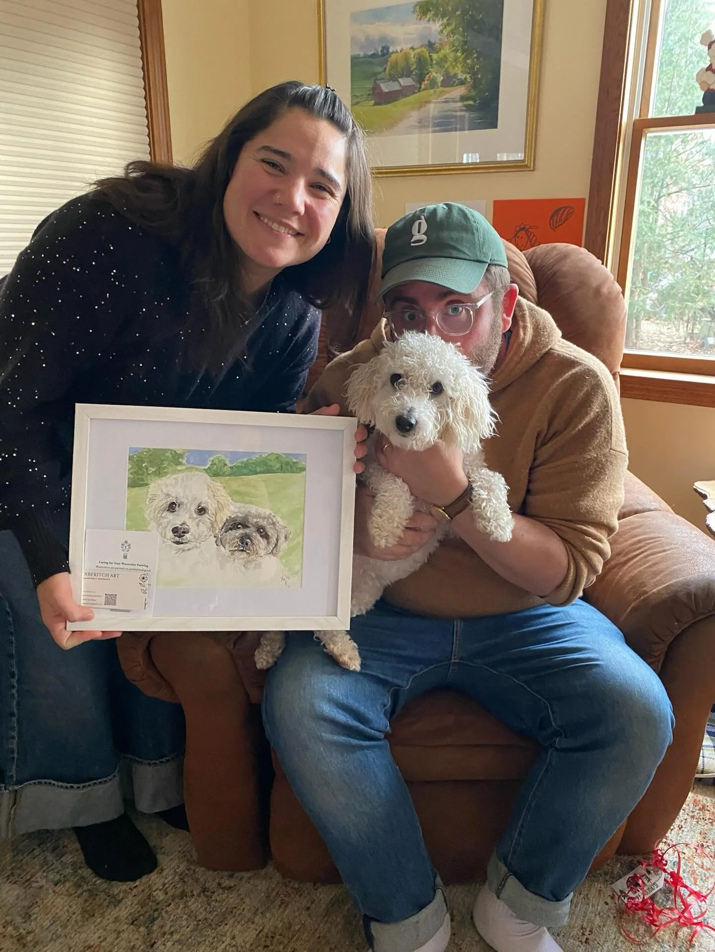 🎄✨ Finally allowed to share one of my holiday commissions!

This custom piece was a portrait of their two dogs, and the photo I&rsquo;m sharing shows the human parents holding one of their real pups alongside the finished painting. Seeing art and re