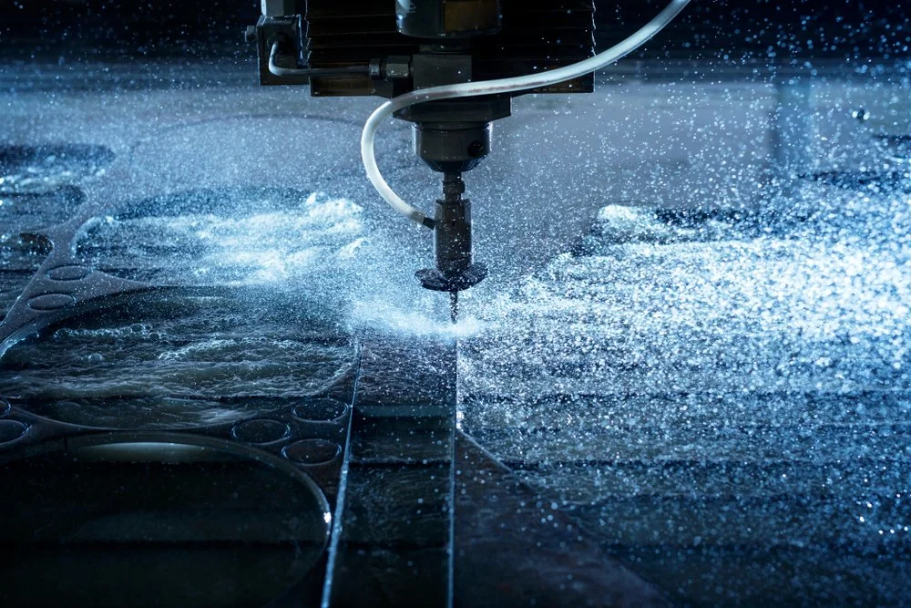 A laser cutting machine cutting sheet metal, producing sparks and debris.