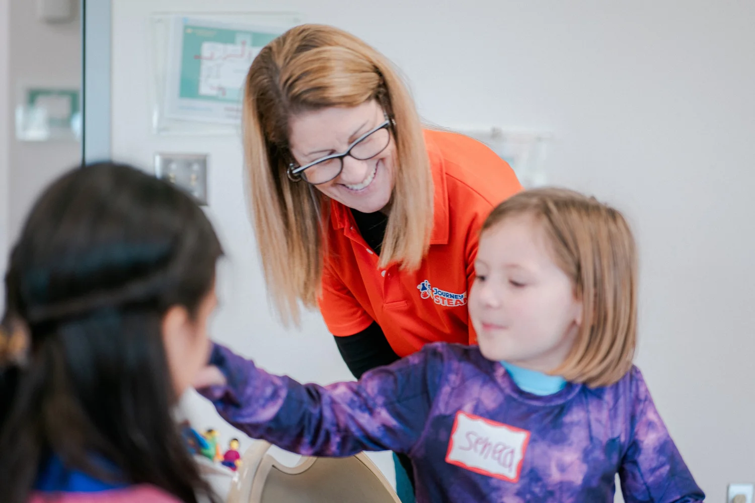 A Journey to STEAM instructor working with kids at a table