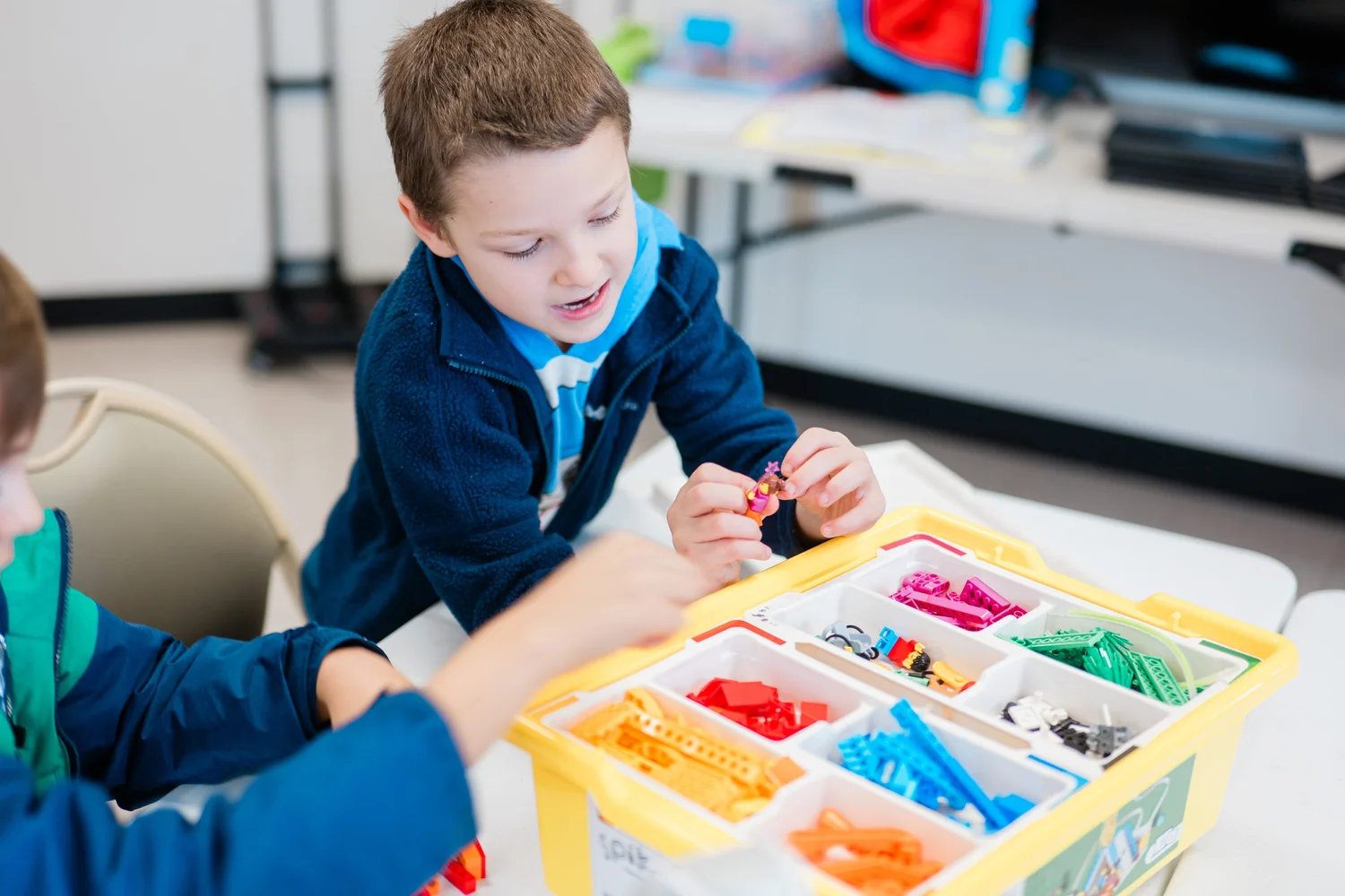 Preschoolers building with colorful blocks