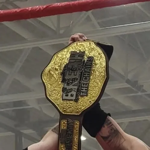 break+the+chains+belt+held+high.jpg
