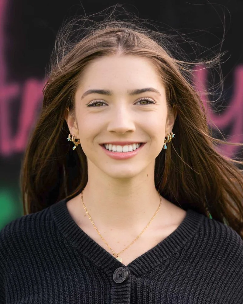 Smiling young woman in an outdoor senior portrait at Hall High School in West Hartford, Connecticut, photographed by Rick Morgan.