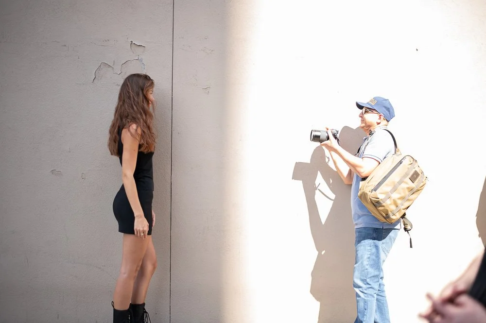 Photographer working with a model during a natural-light portrait workshop in New York City.