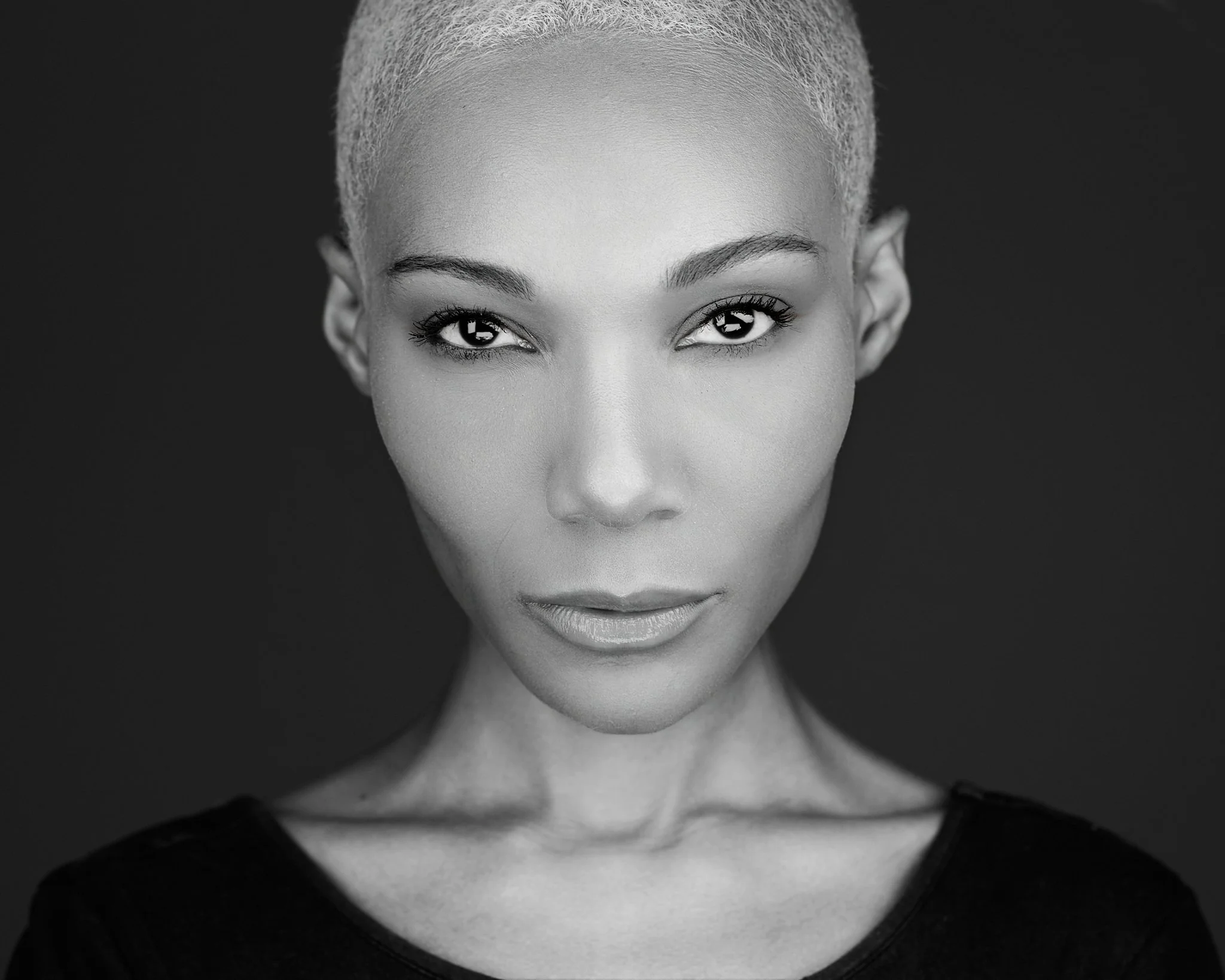 Photography Manchester CT. Black and white portrait of a person with short hair looking directly at the camera.