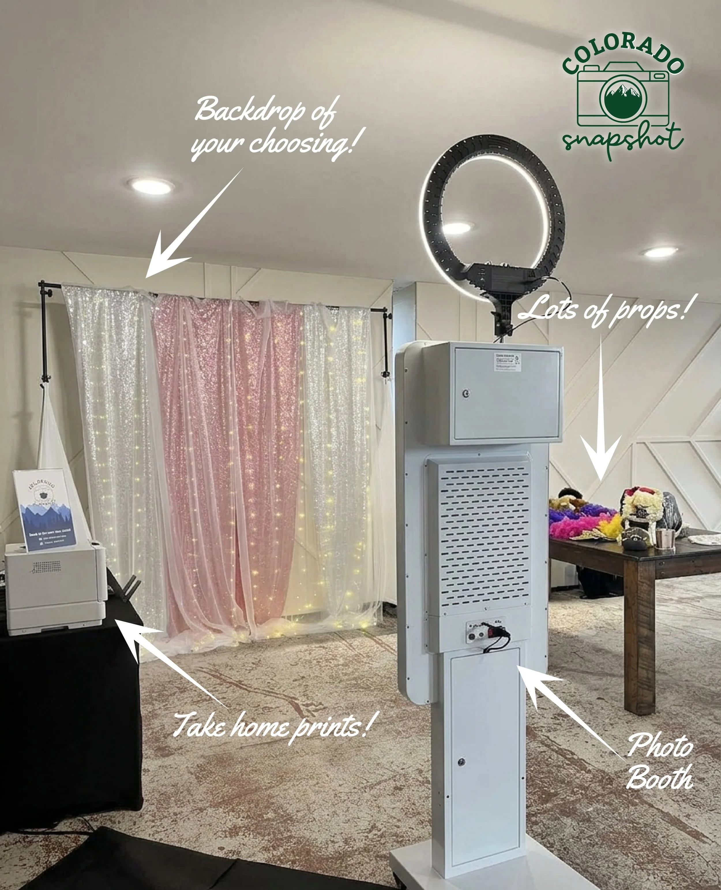 Photo booth setup with pink and white sequin backdrop, ring light, and props on table for a photo booth event.
