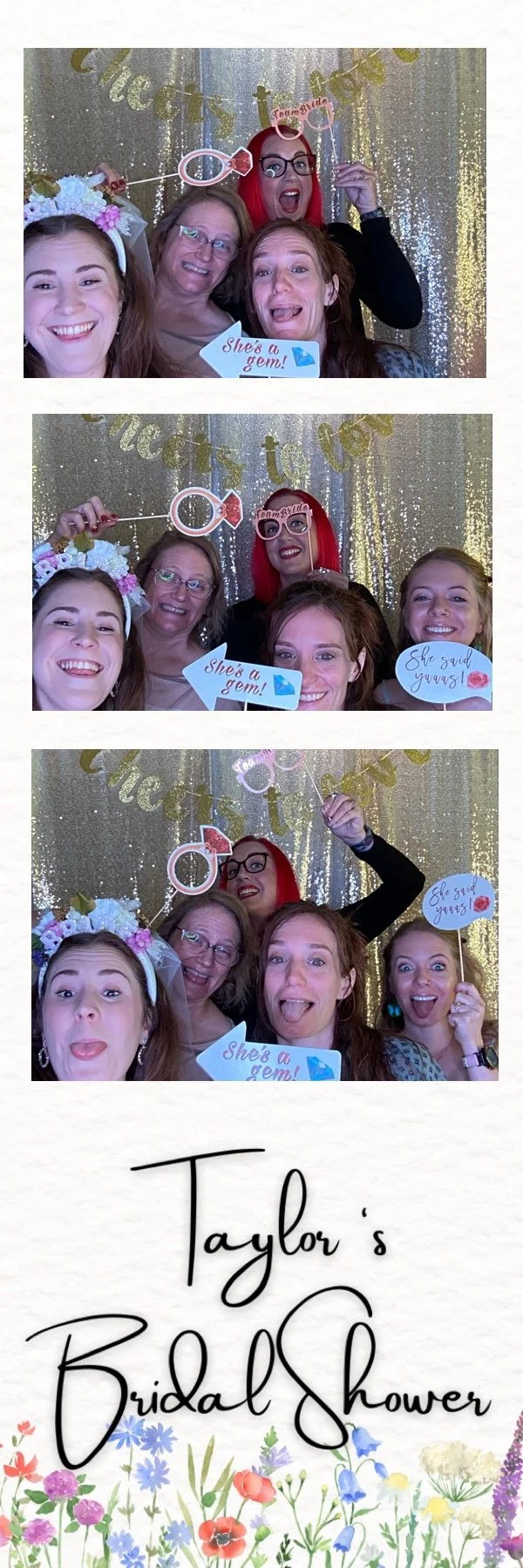 Four women smiling and posing with photo props in a photo booth at a bridal shower, with a glittery gold backdrop and a banner that reads "Cheers to Love."