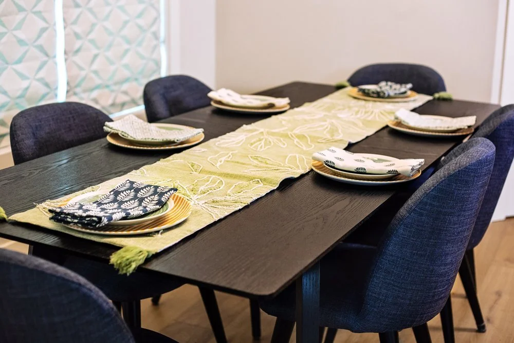 Elegant dining room with sculptural furniture and global-inspired decor, styled with intention in Chapel Hill, NC.