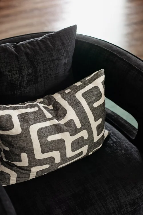 A close-up of two pillows with a geometric pattern in a cozy elevated living space in Chapel Hill, NC.