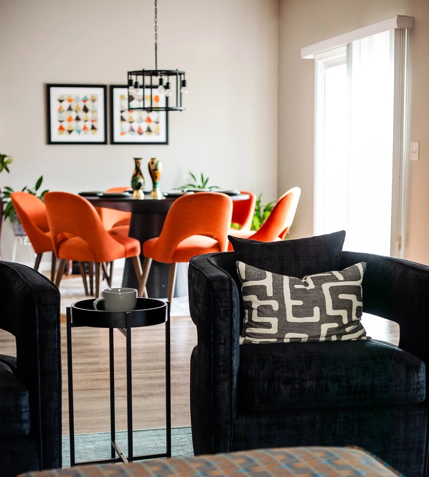 Cozy and contemporary living space with warm tones and custom furnishings, created for a busy professional in Raleigh, NC.