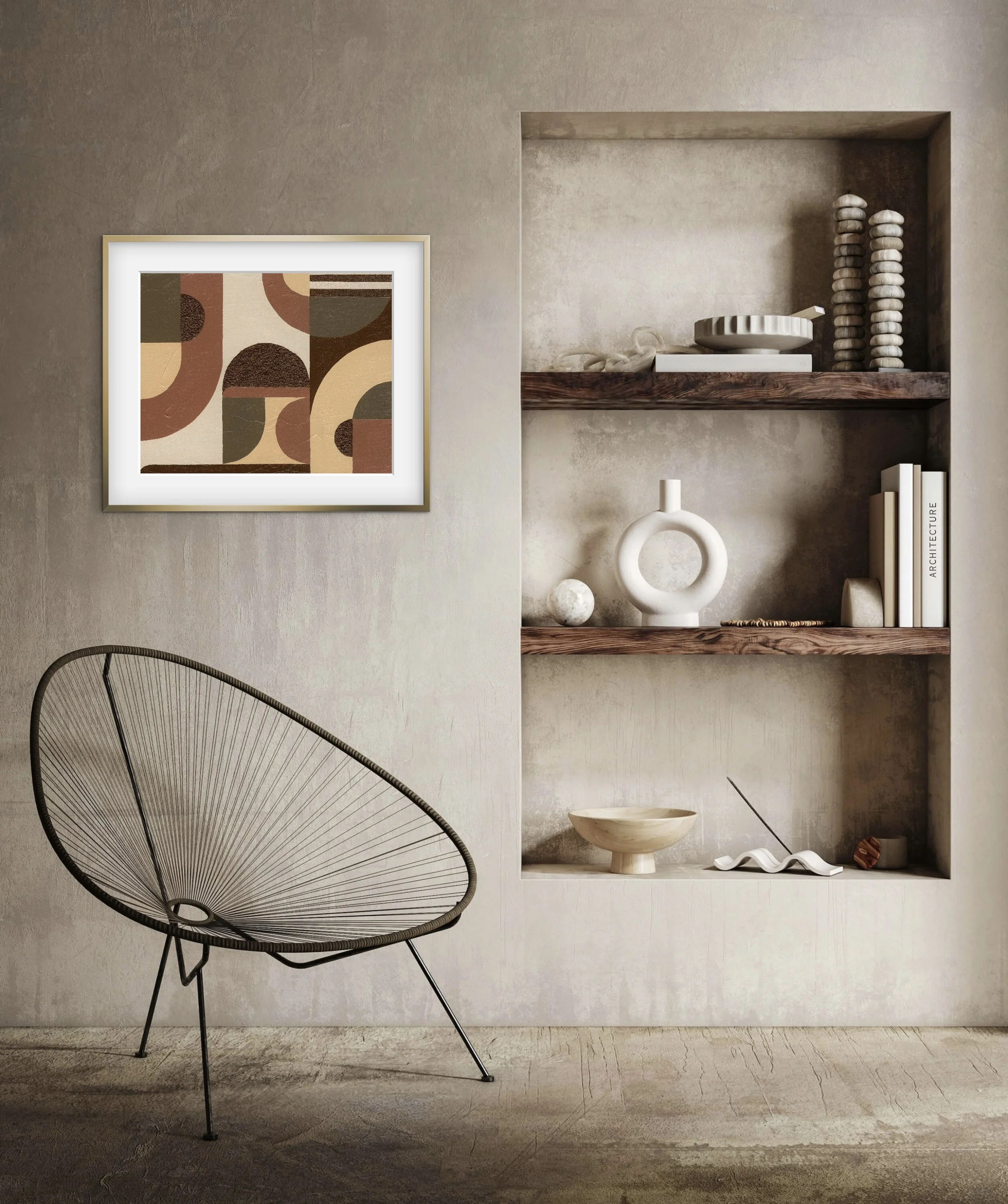 A modern interior room wall with a beige textured surface. A framed abstract artwork with earthy tones and geometric shapes hangs on the left side. To the right, there is a built-in wooden shelf with decorative items including stacked stone sculptures, a white bowl, a white book titled 'Architecture,' and sculptural objects. In the lower left corner, part of a black wireframe lounge chair with a rounded design and thin legs is visible.