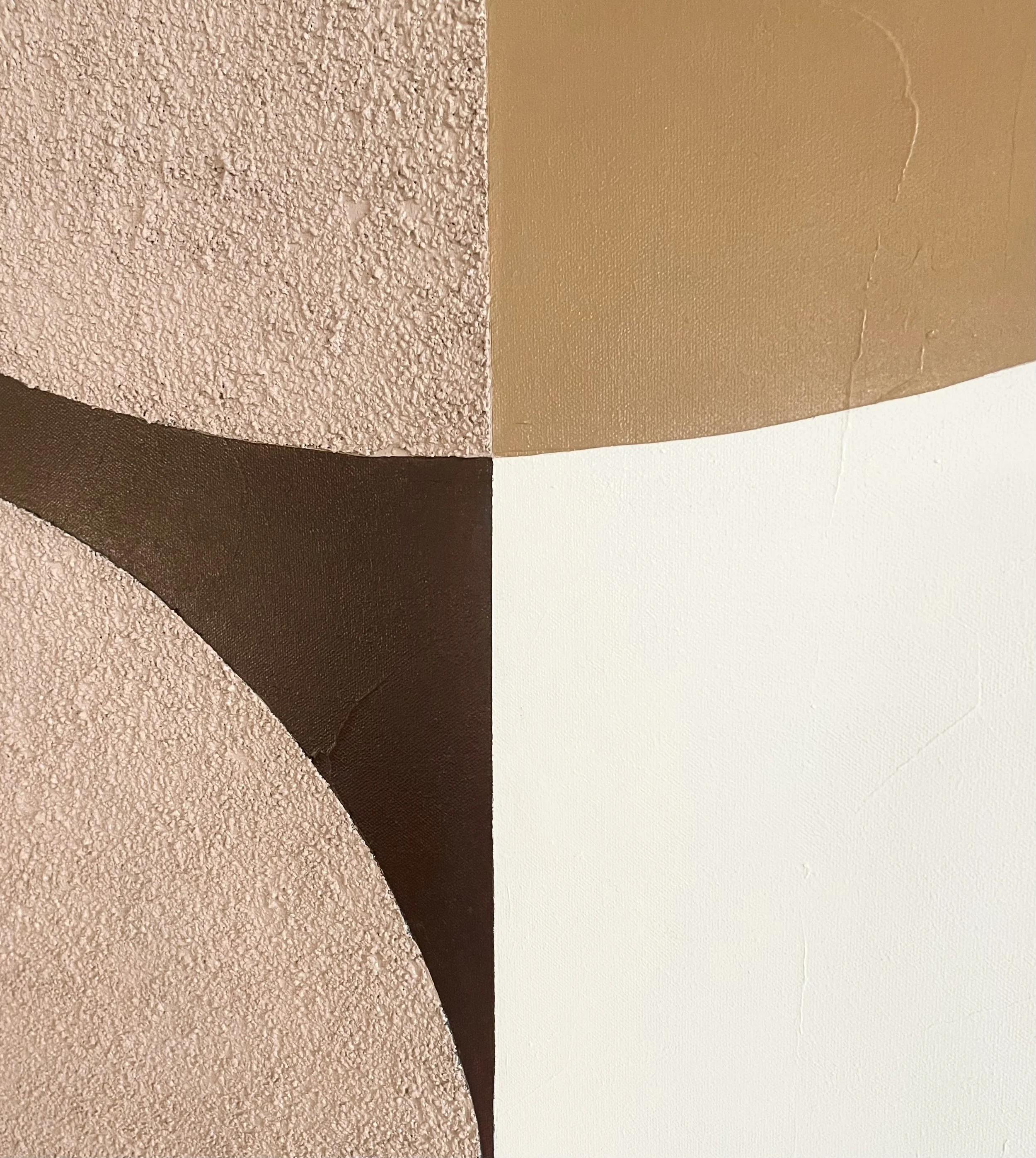Close-up of different textured paint samples in beige, brown, and white colors.