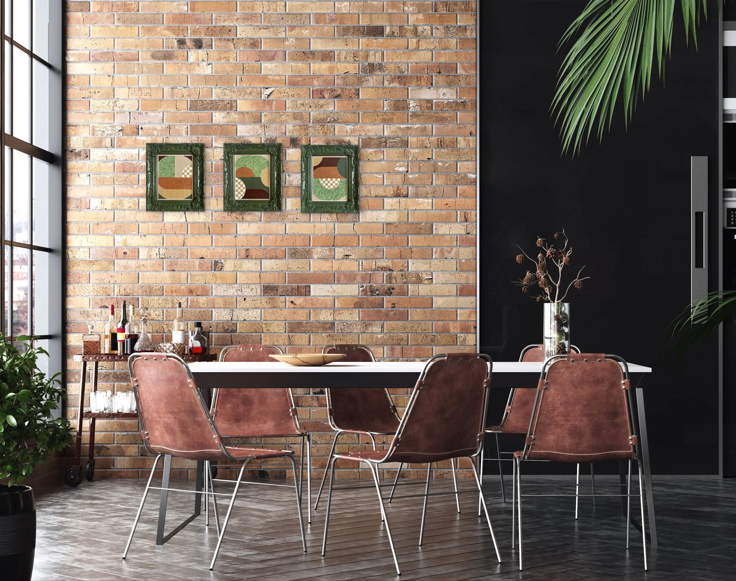 A modern dining area with a brick accent wall decorated with three abstract art frames, a black wall with a large green plant, and a table with metal chairs.