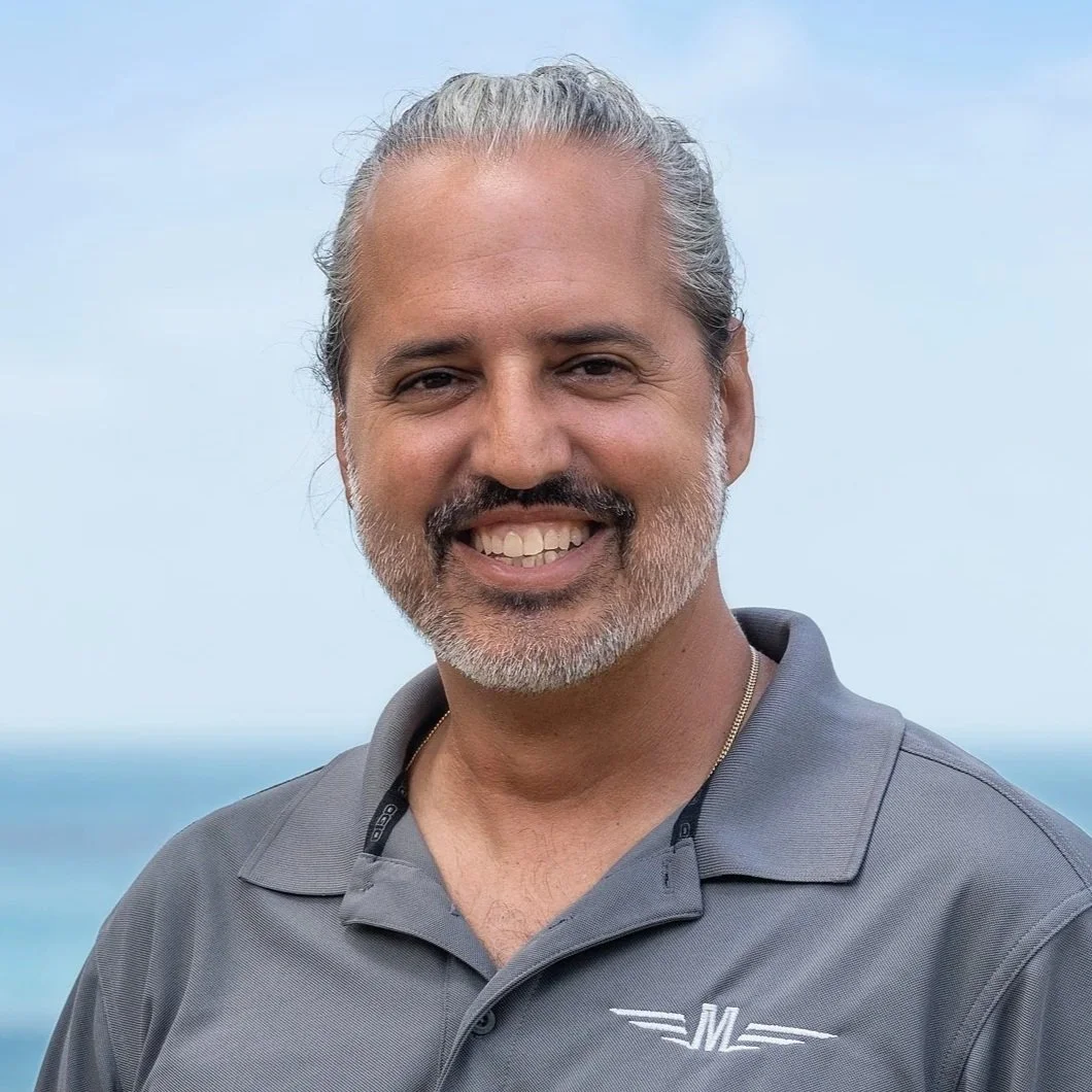 Captain Tyrone LaRue on the beach in a MAVERICK crew shirt.