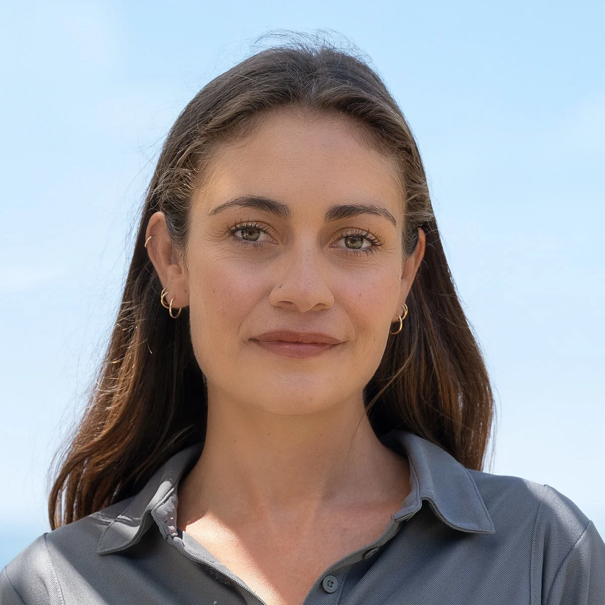 Summer Gill, MAVERICK's stew/deckhand, on the beach in a MAVERICK crew shirt.