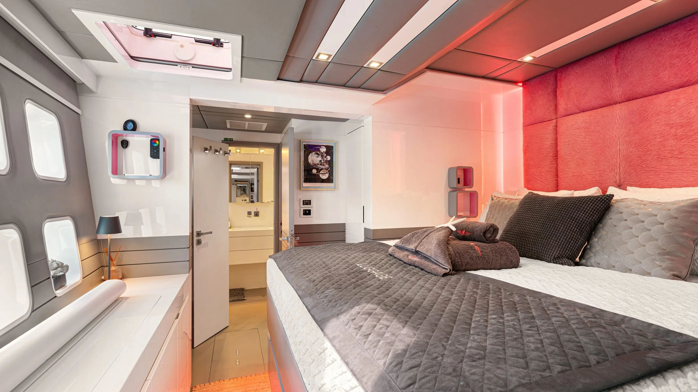 MAVERICK master king suite with a pink upholstered headboard, a king bed and the door open to its bathroom, BVI.
