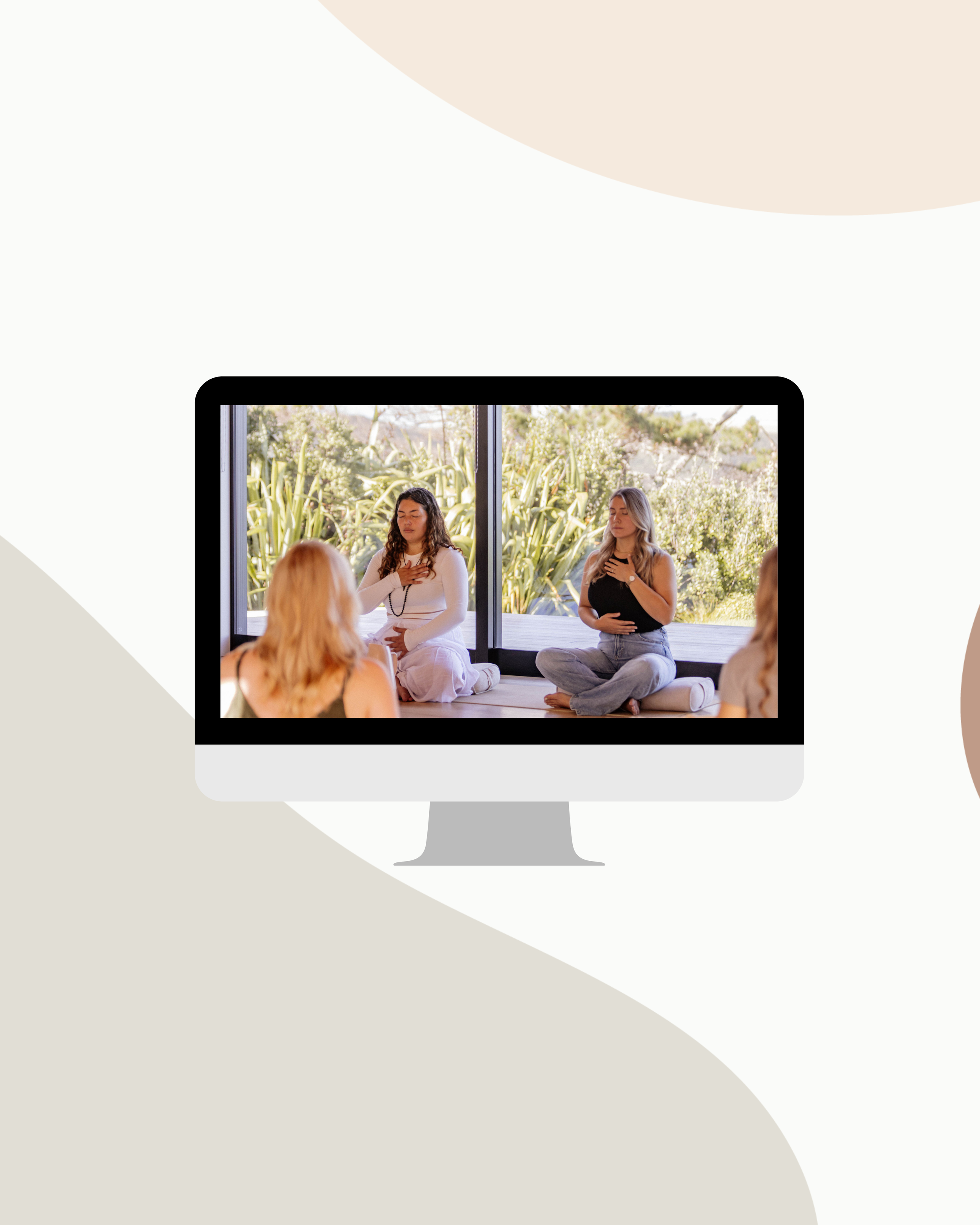 Computer screen displaying a meditation class with four women sitting cross-legged with their hands over their chests outdoors near large windows and greenery