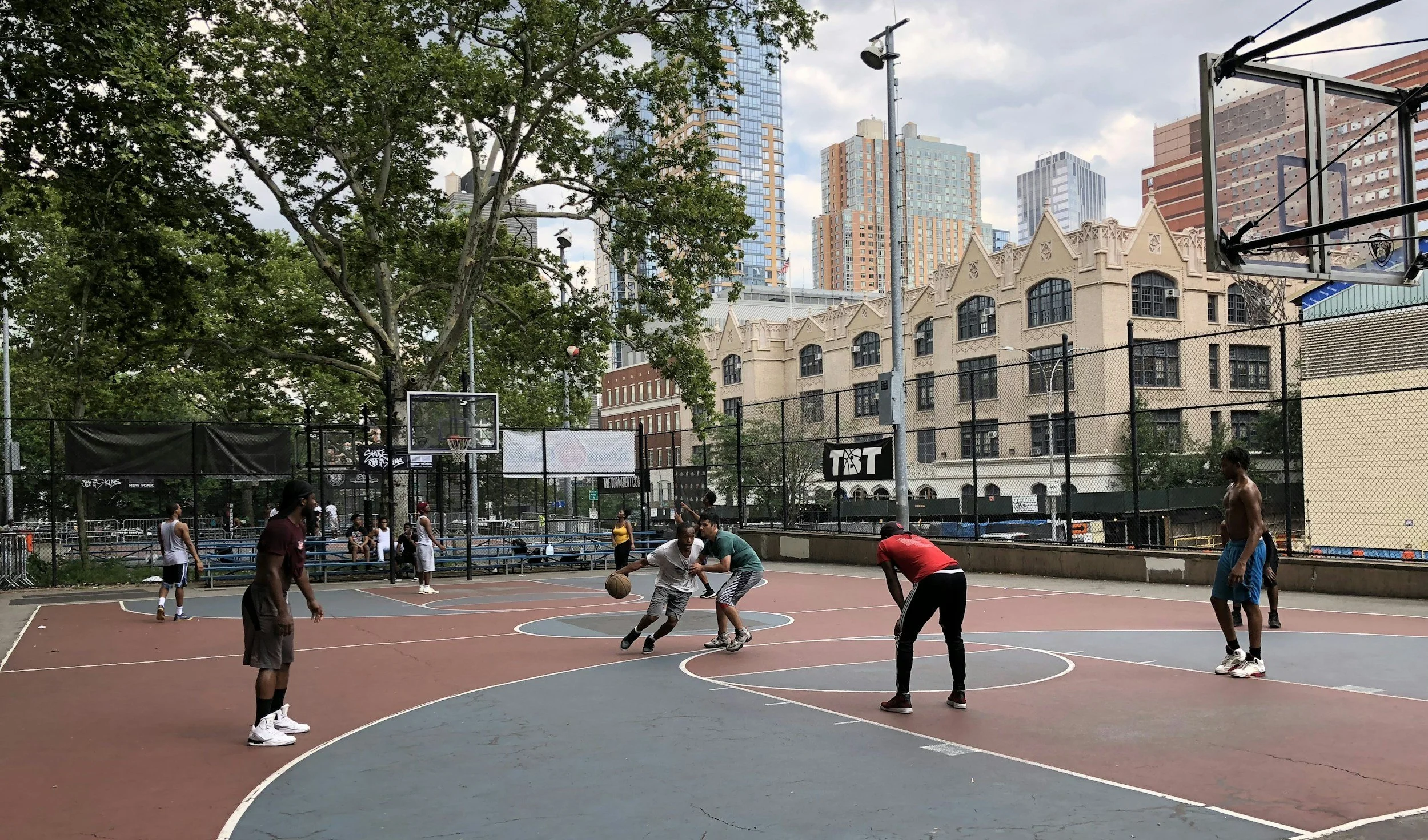 Players in a community basketball court